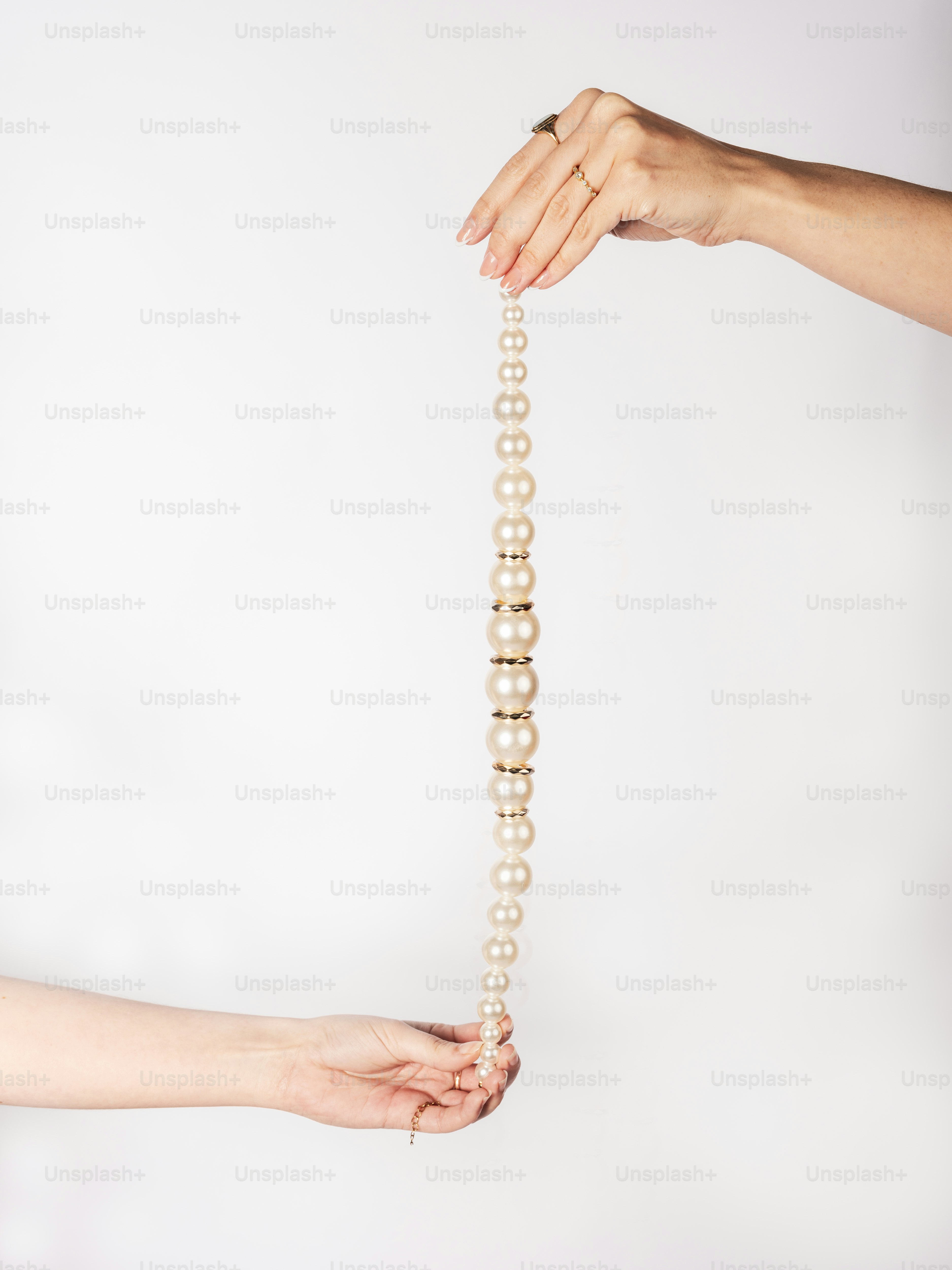 Une femme tenant un collier de perles dans ses mains