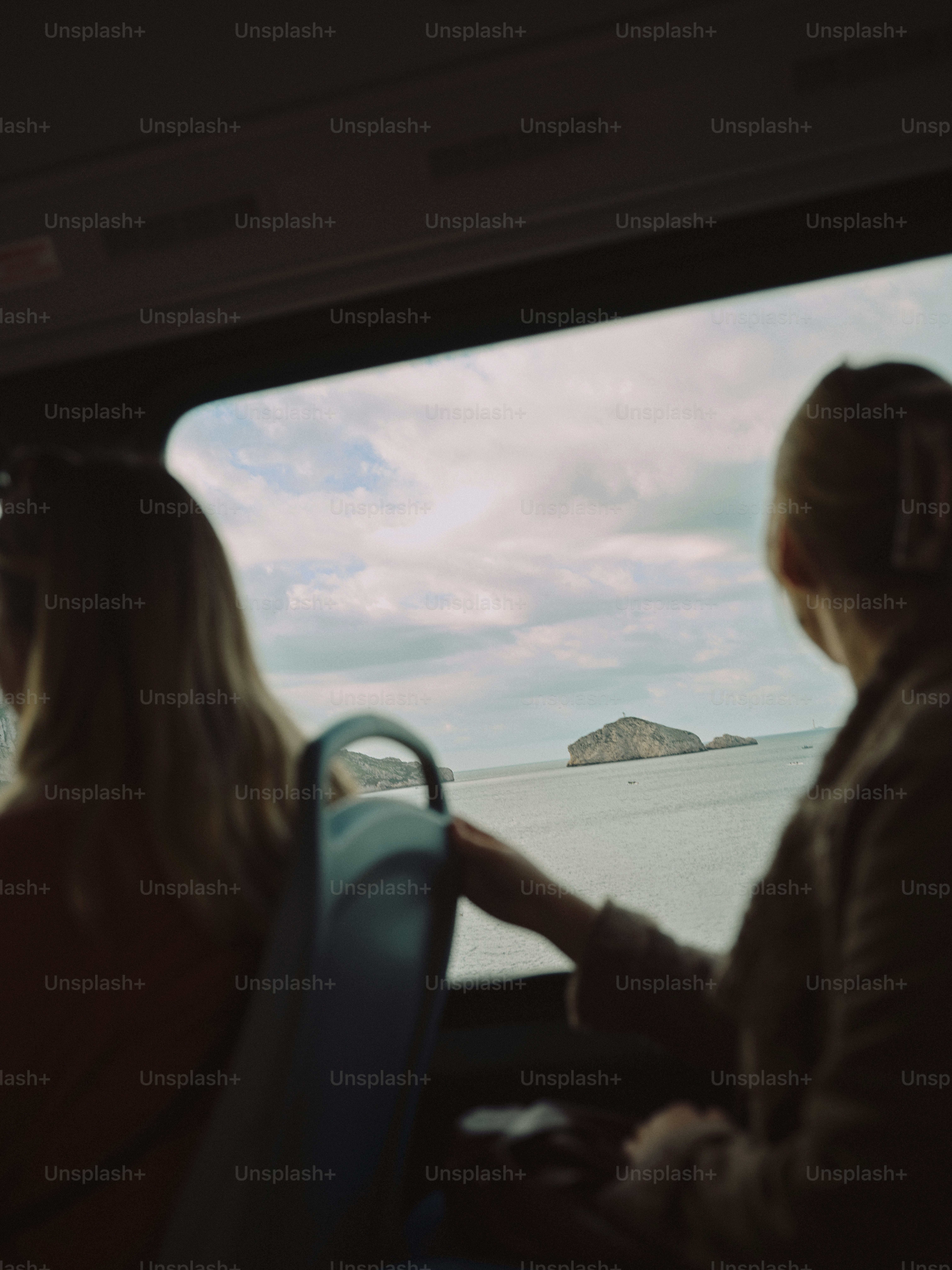 A couple of women riding on the back of a bus