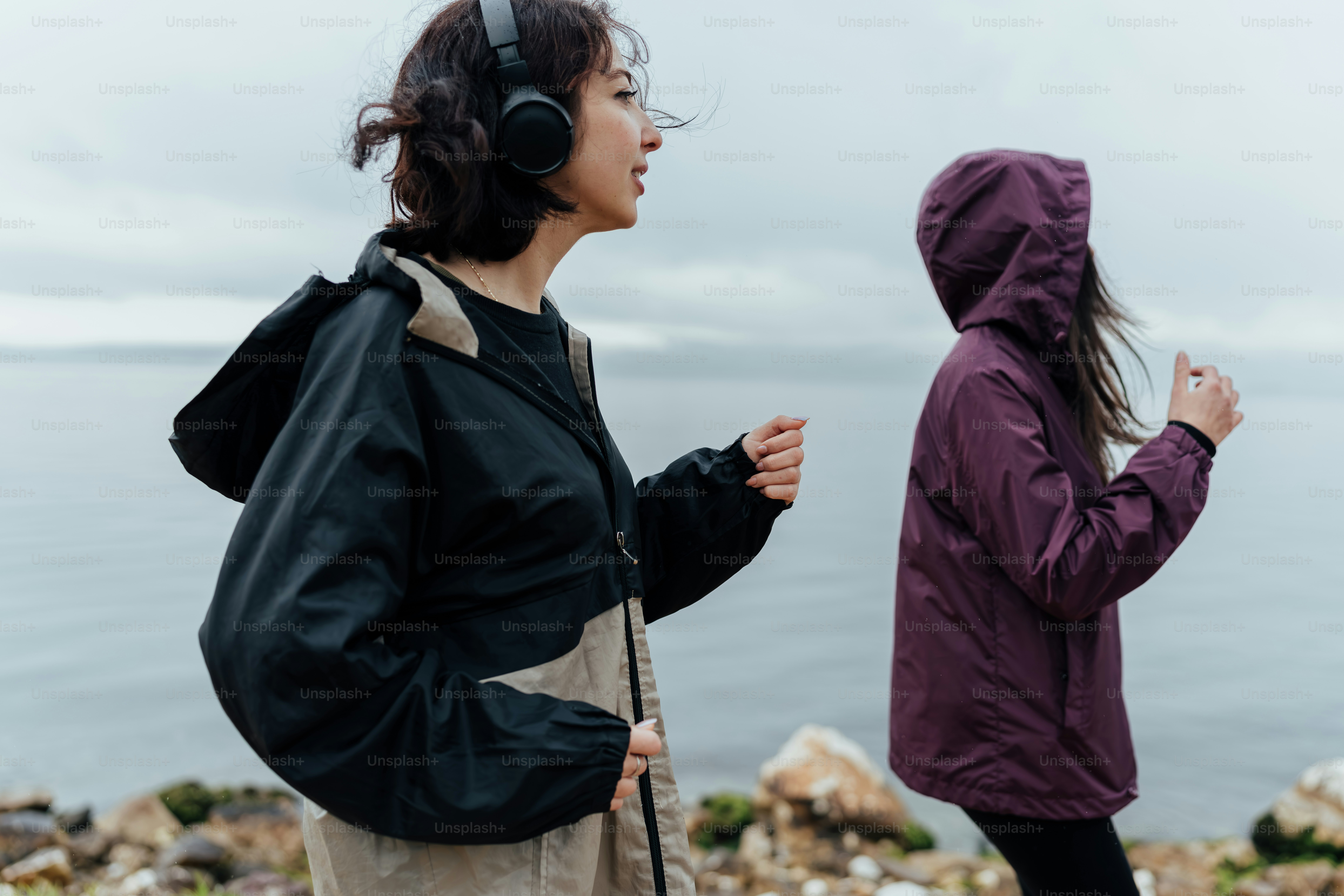 A woman standing next to a man with headphones on