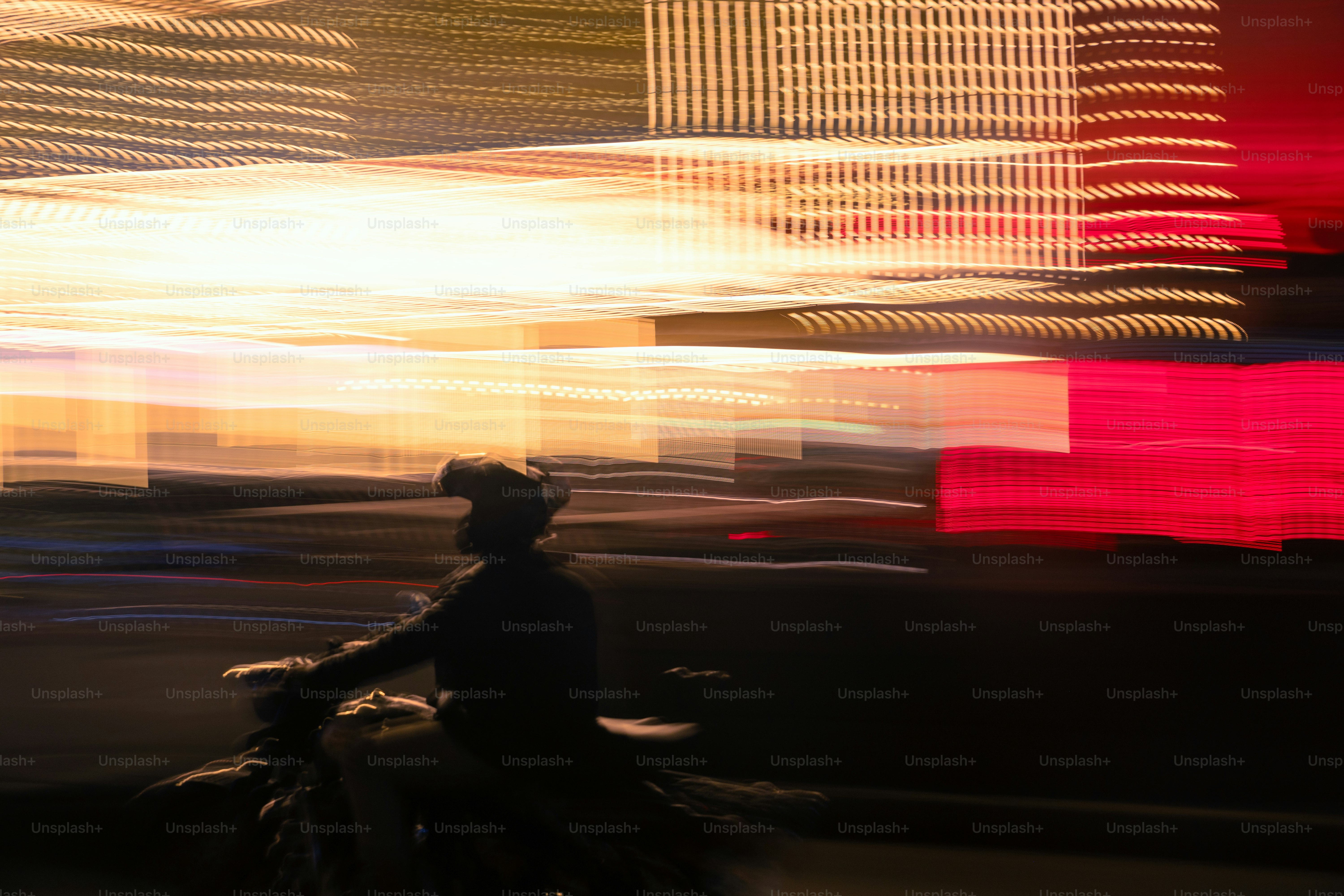 A blurry photo of a person riding a bike