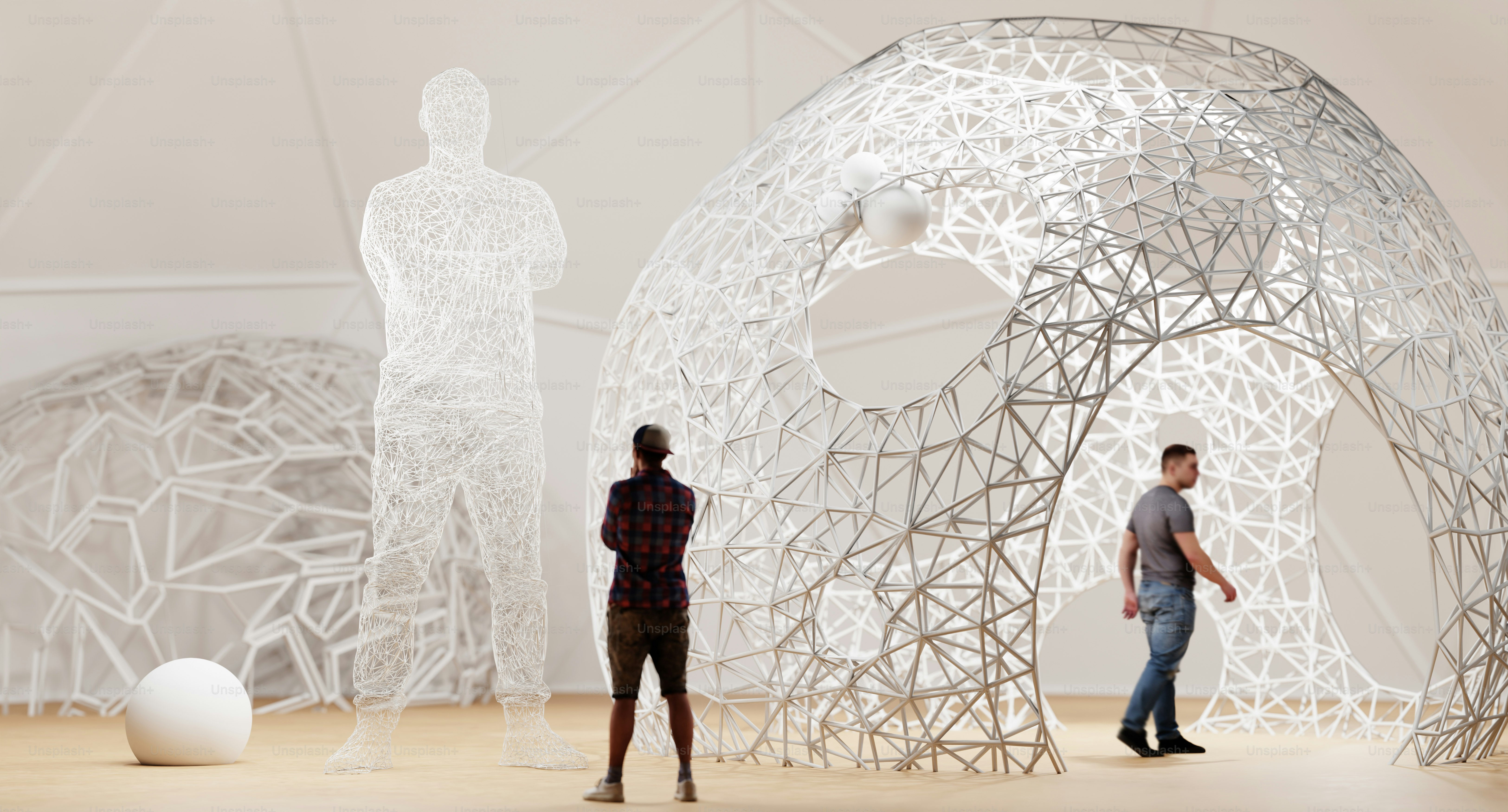 A group of people standing in front of a white sculpture