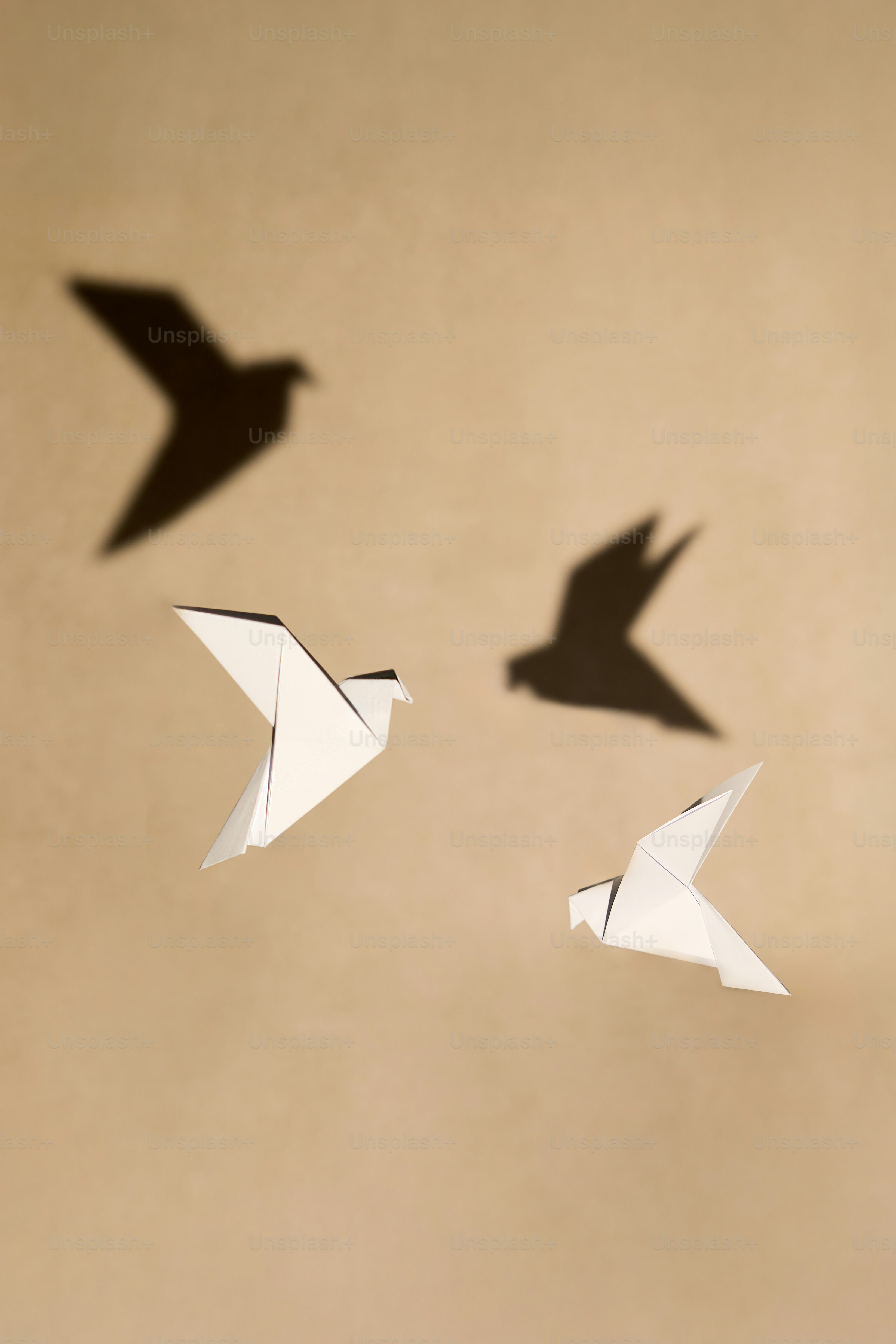 A group of paper birds flying in the air