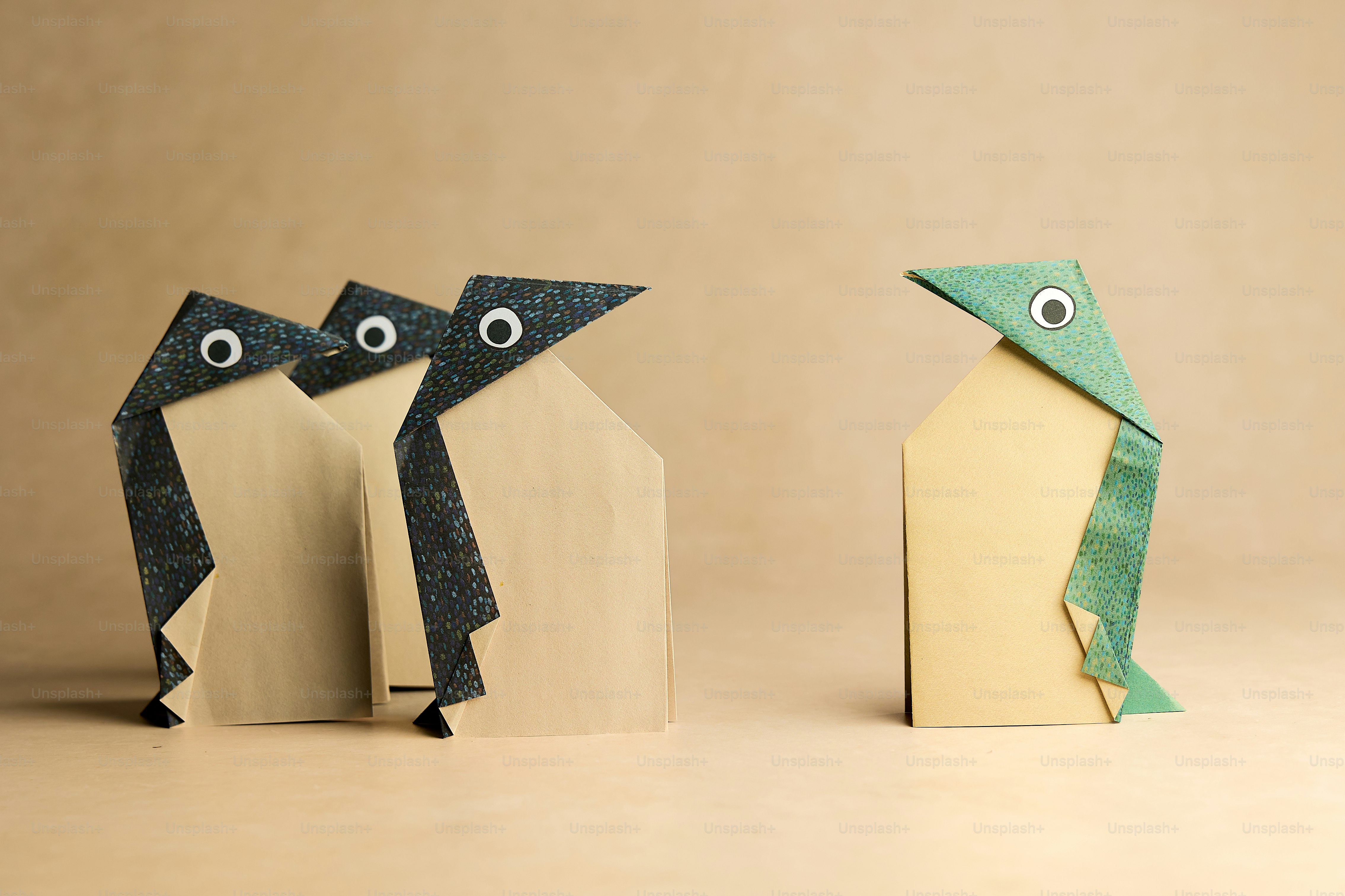 A couple of origami animals standing next to each other