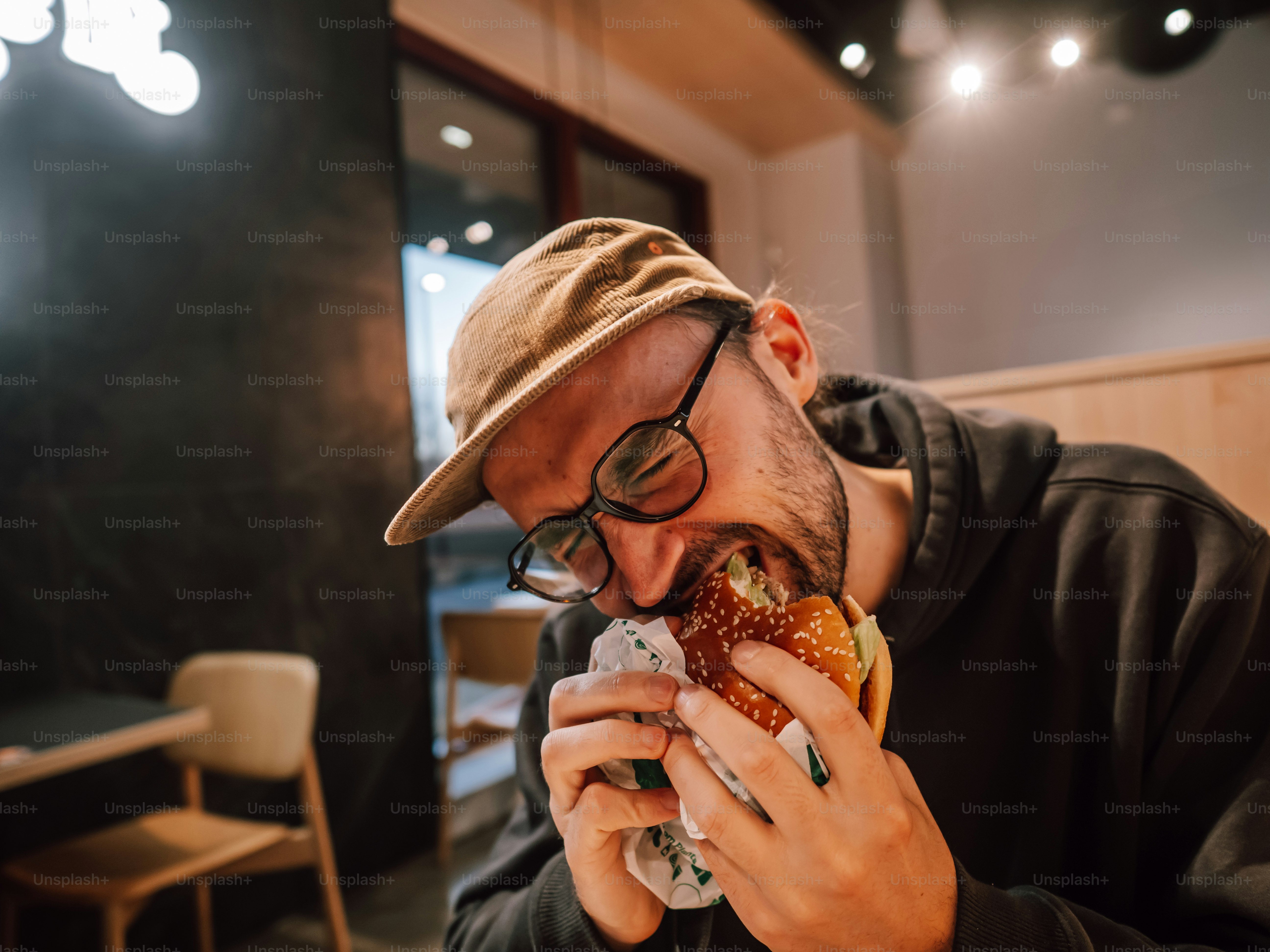 A man eating a hamburger in a restaurant