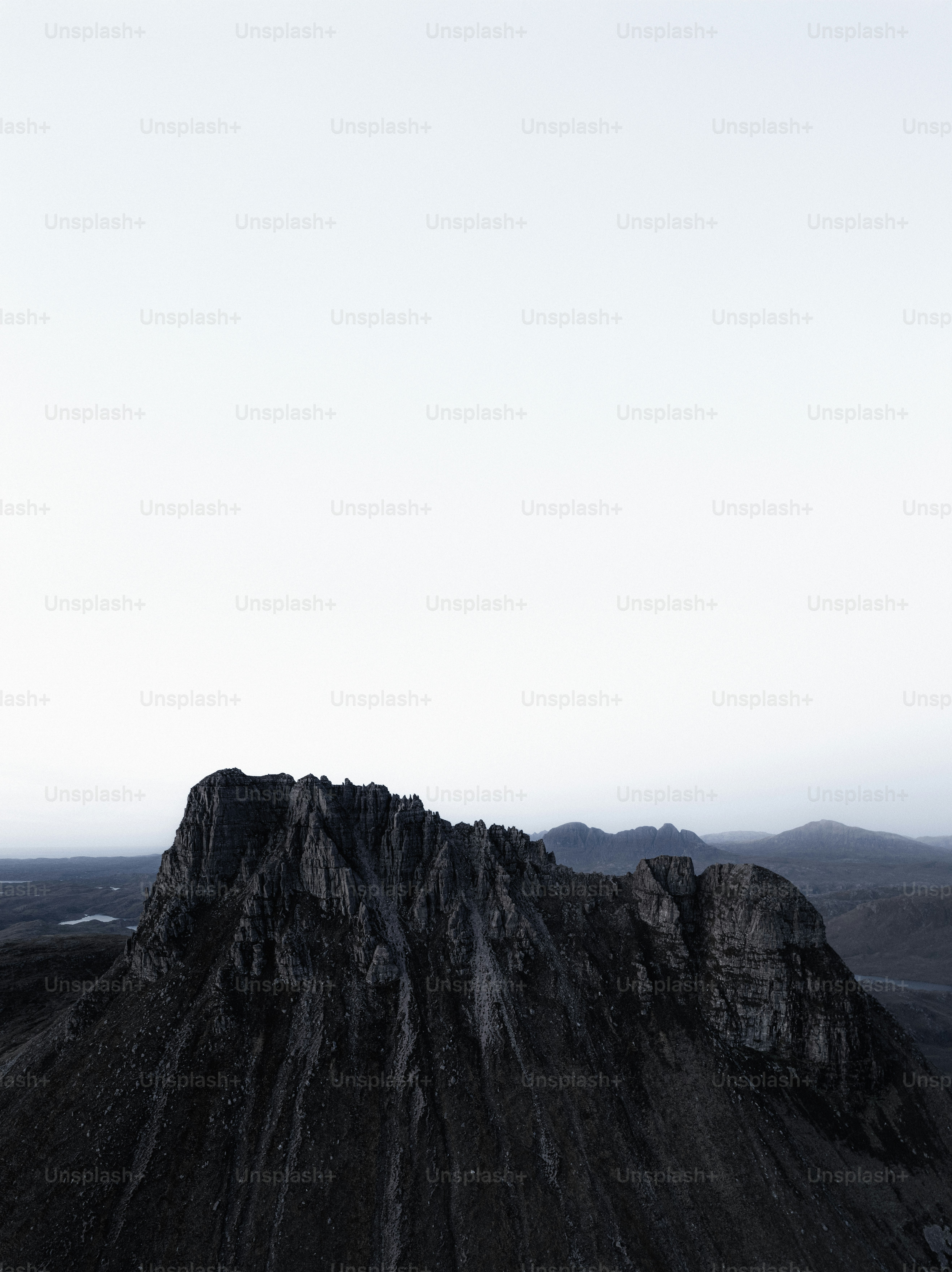A very tall mountain with a sky in the background