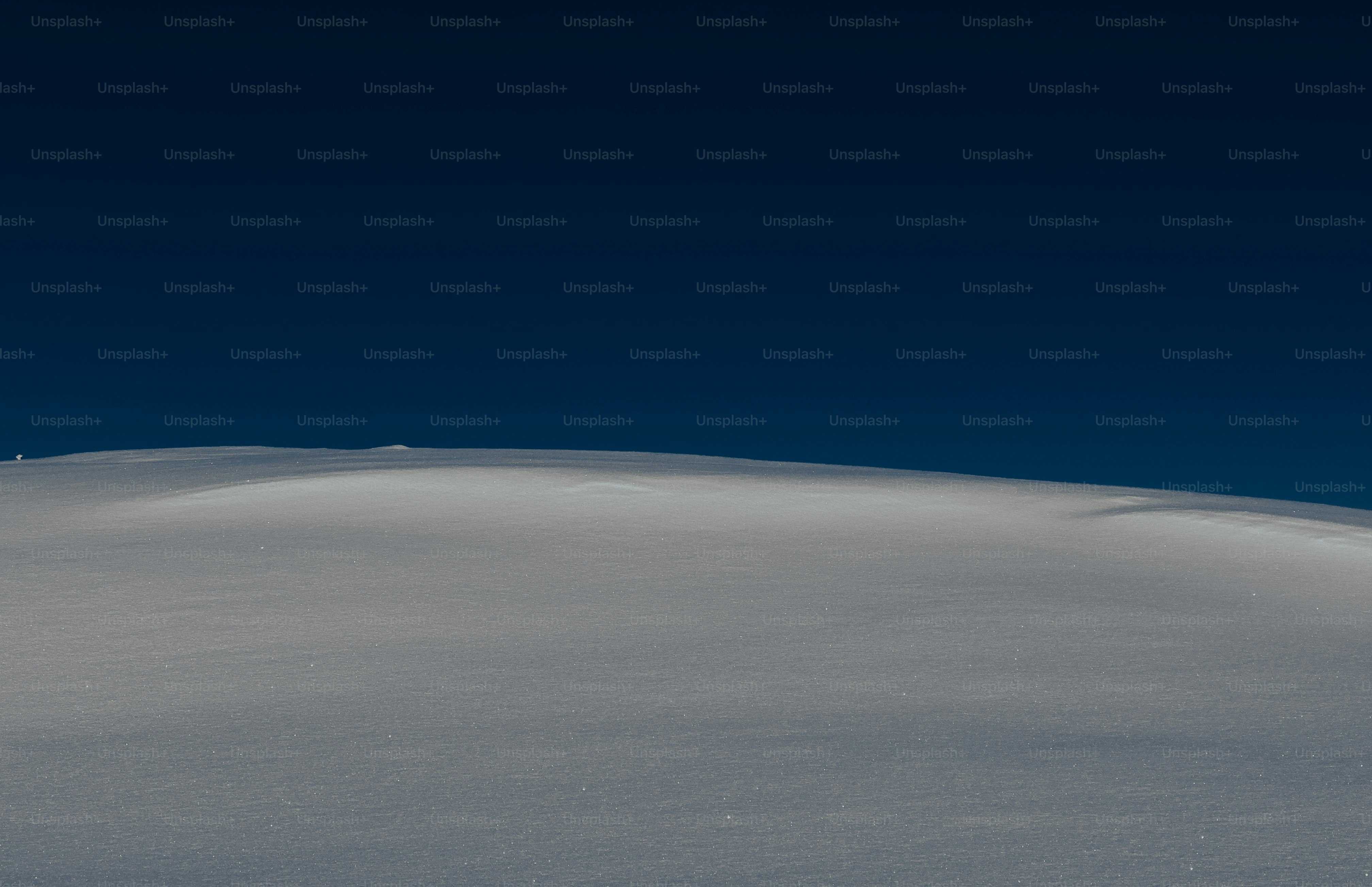 A person skiing down a snow covered slope