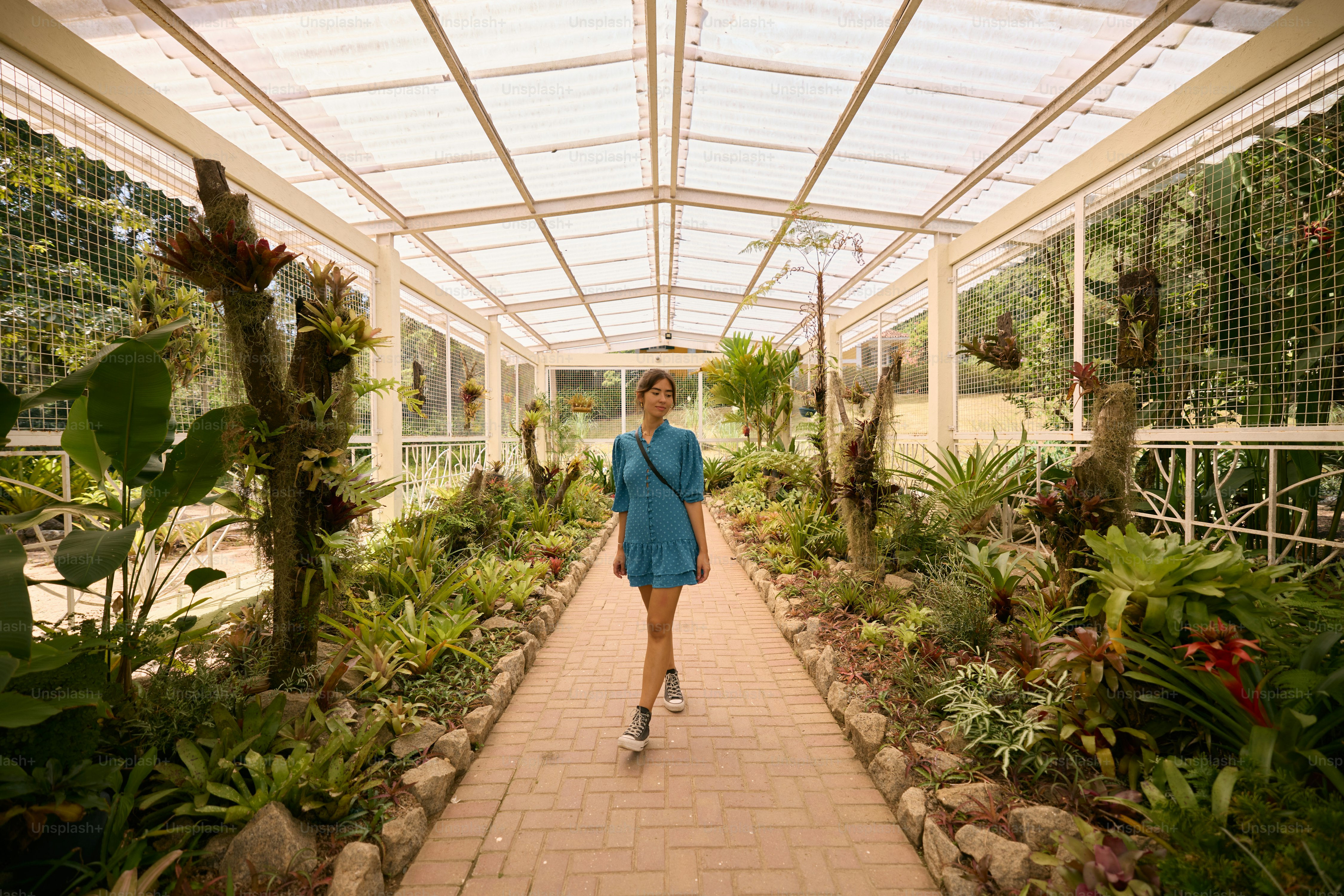 A woman in a blue dress walking down a walkway