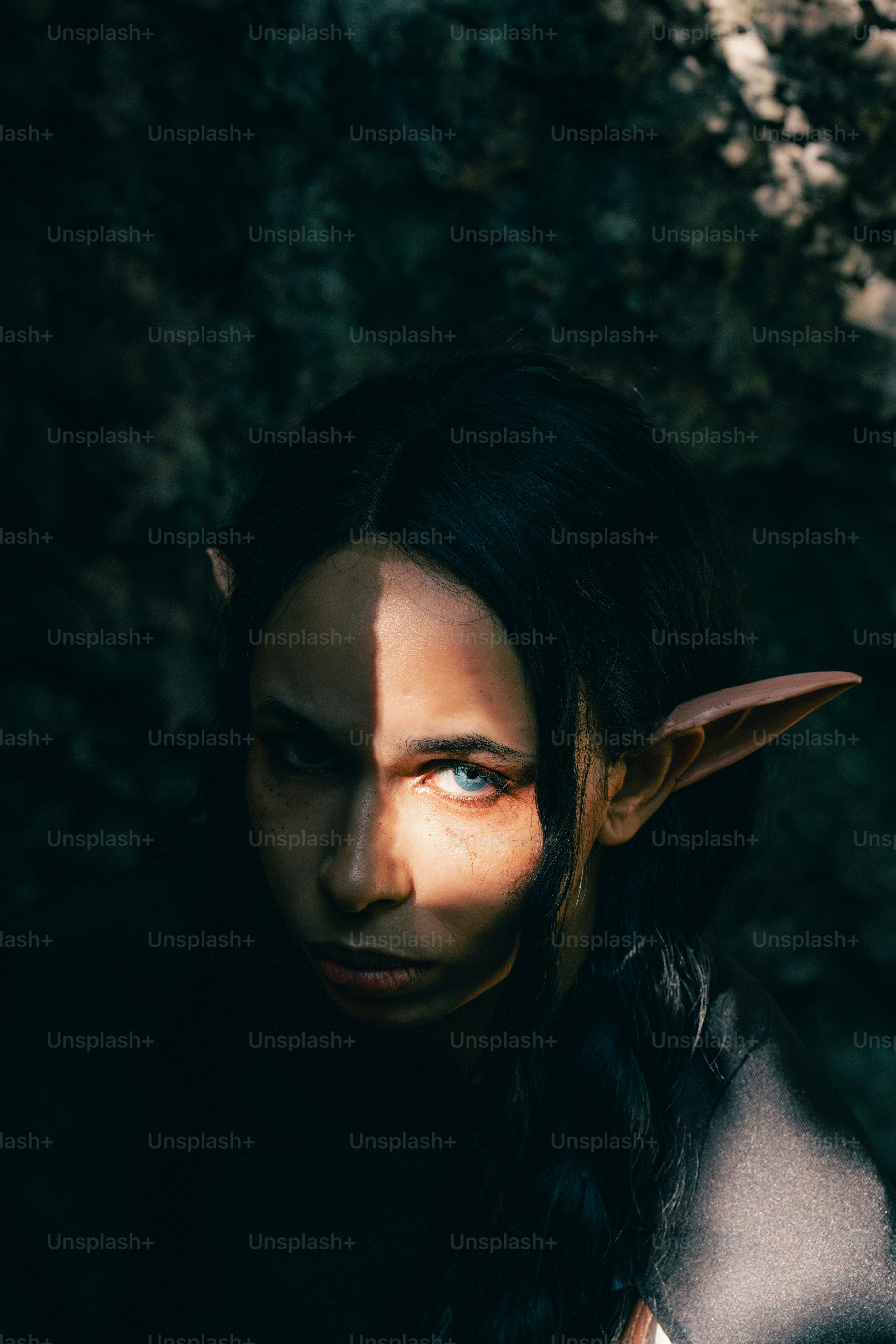 A woman with long hair and a horned face