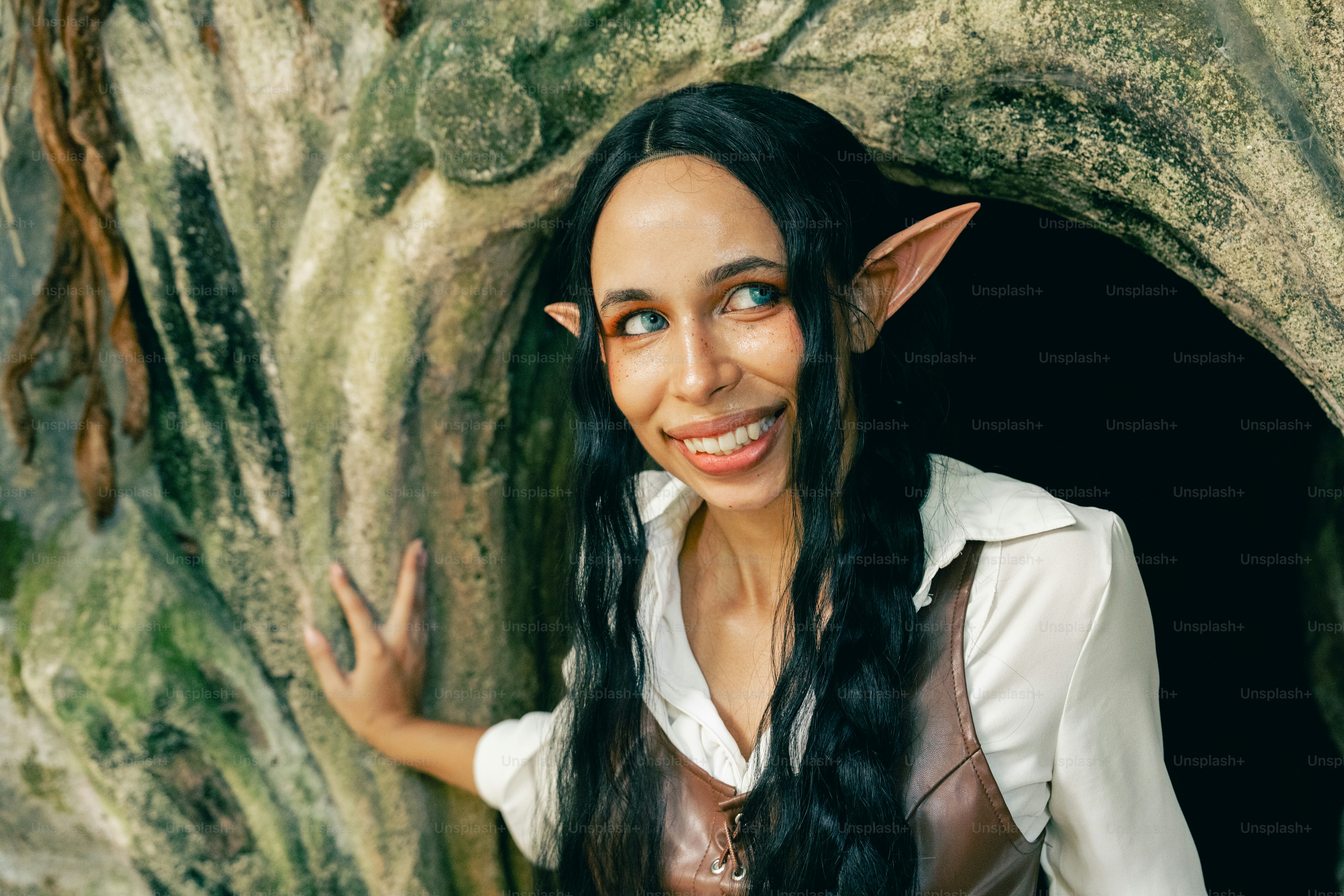 A woman with long black hair and a white shirt