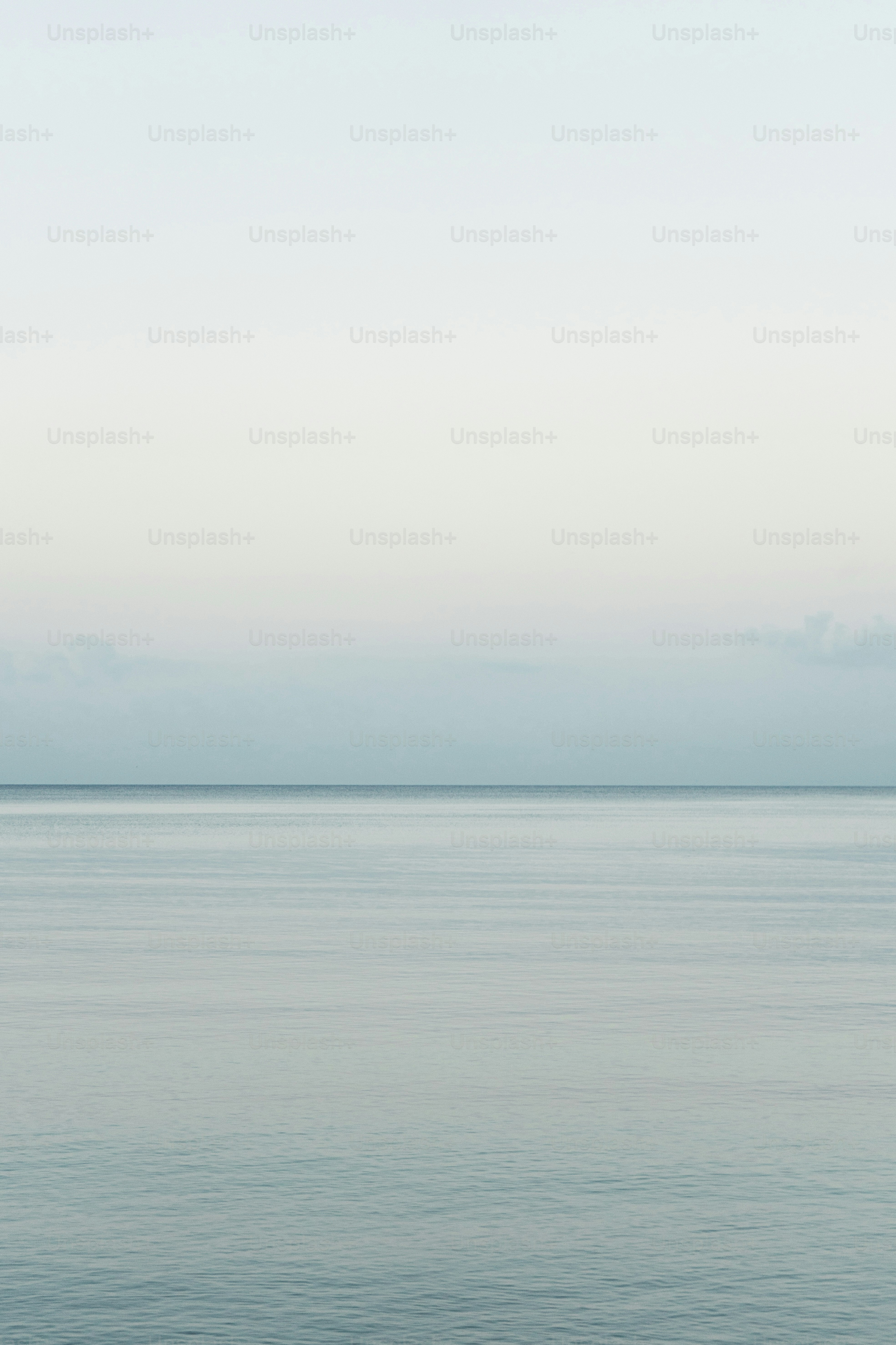 A large body of water sitting under a blue sky