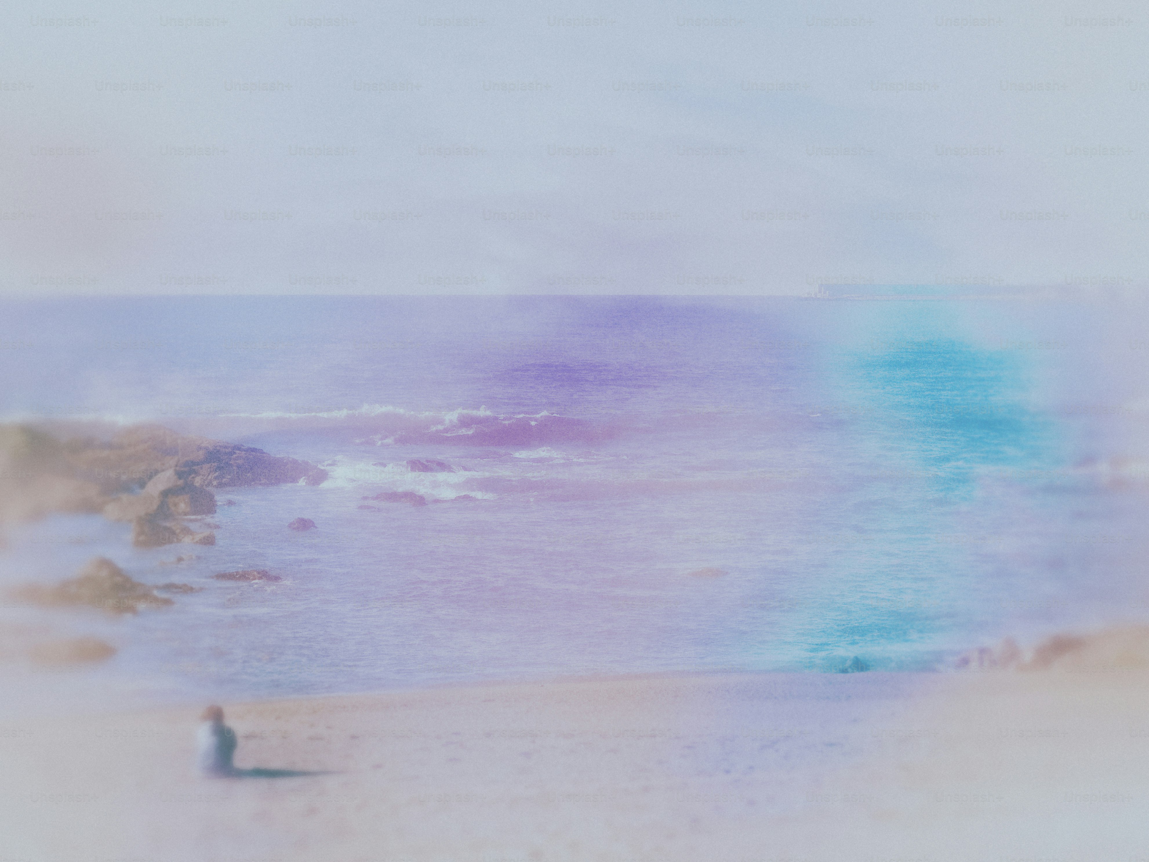 A blurry photo of a person standing on a beach