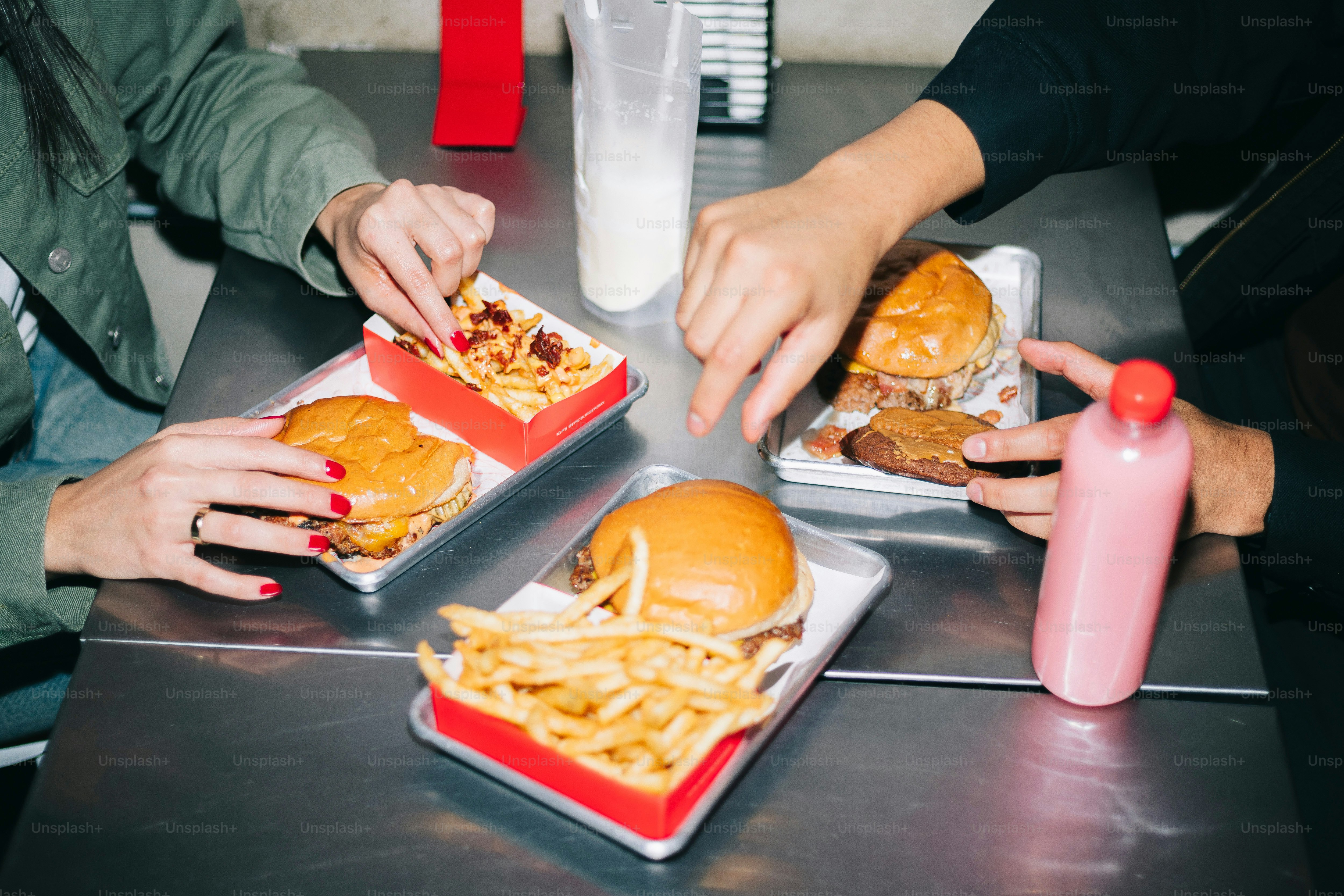 A group of people sitting around a table eating food