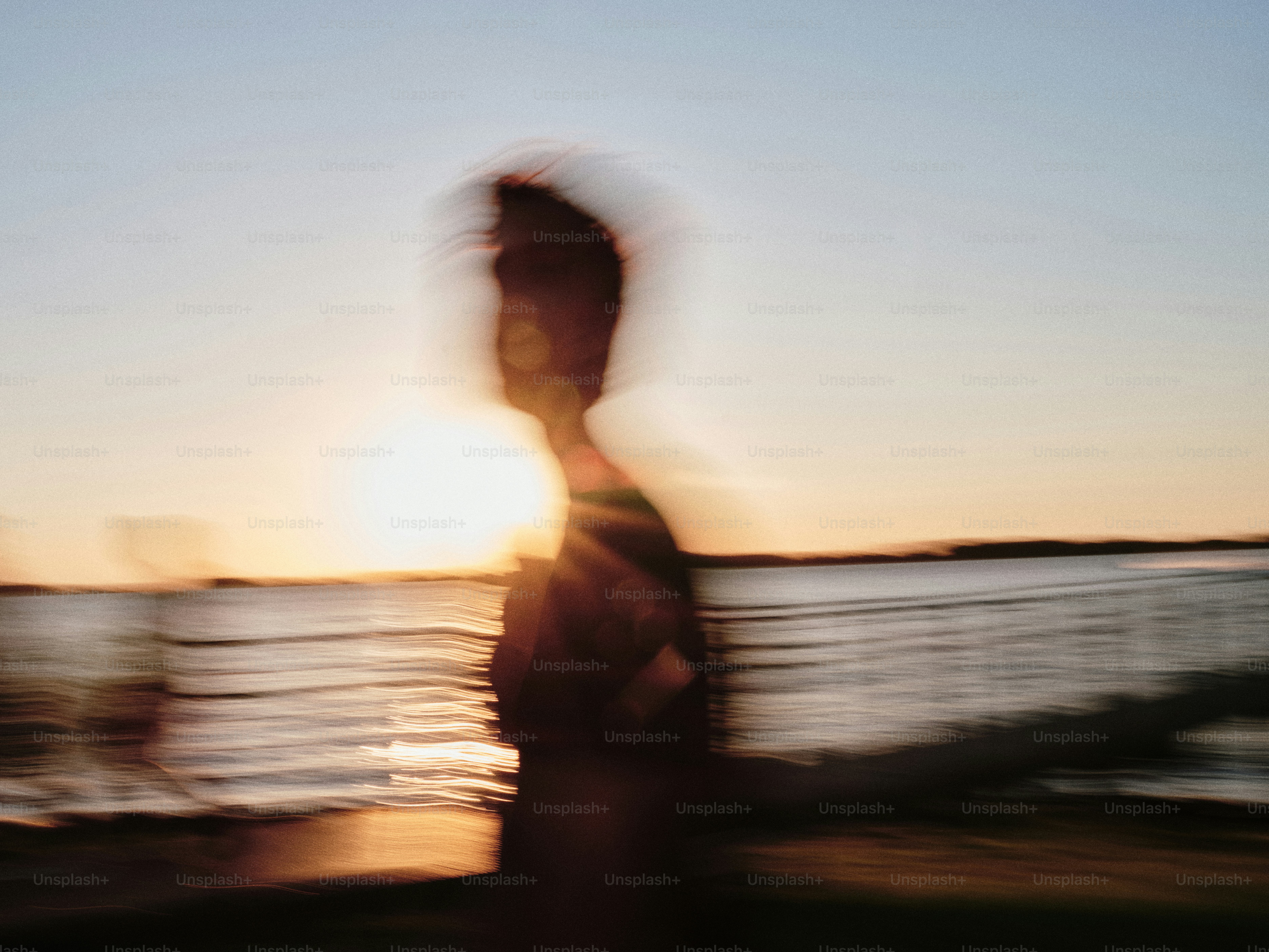 A blurry photo of a person walking on the beach