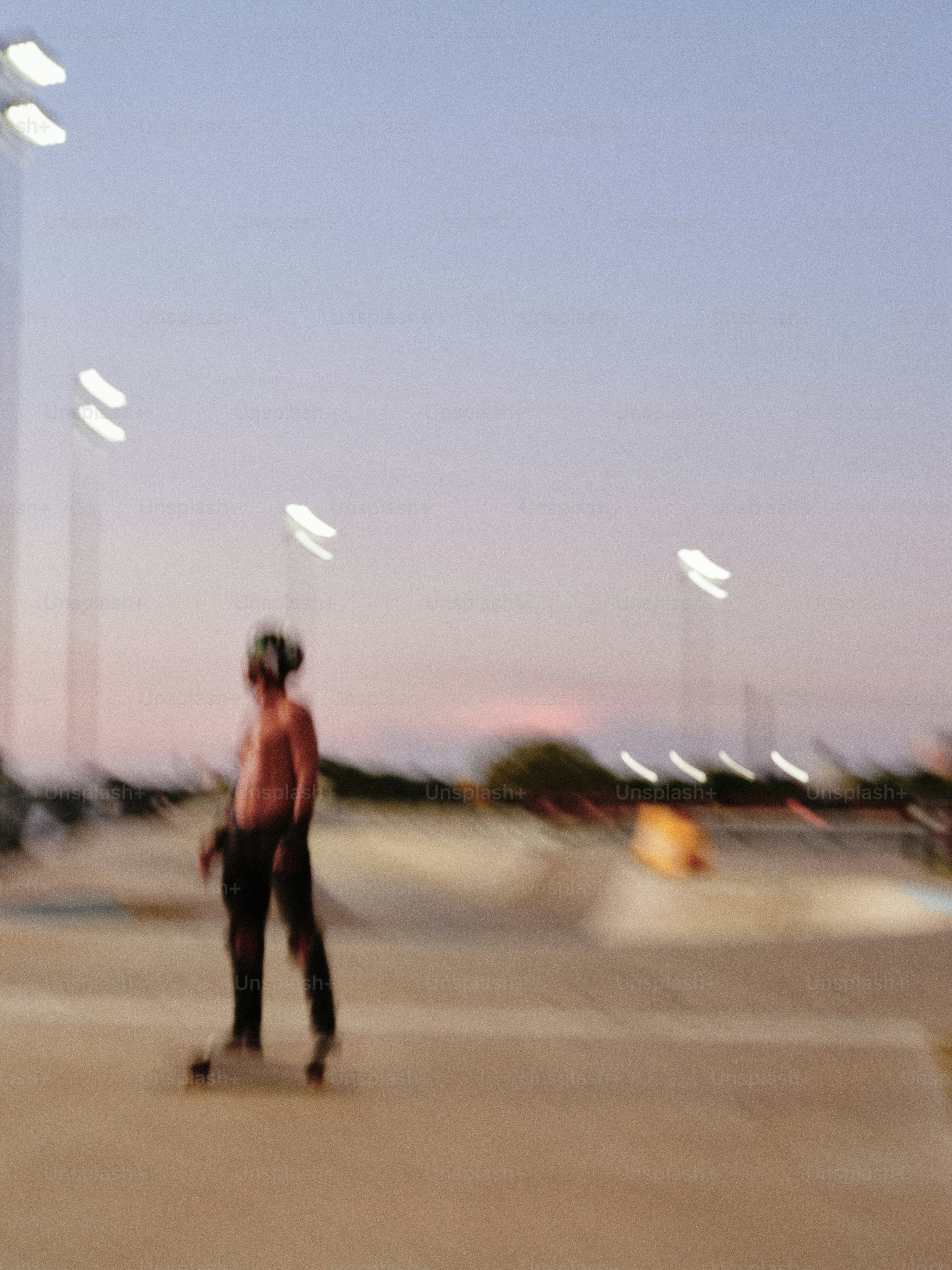 A man riding a skateboard across a parking lot