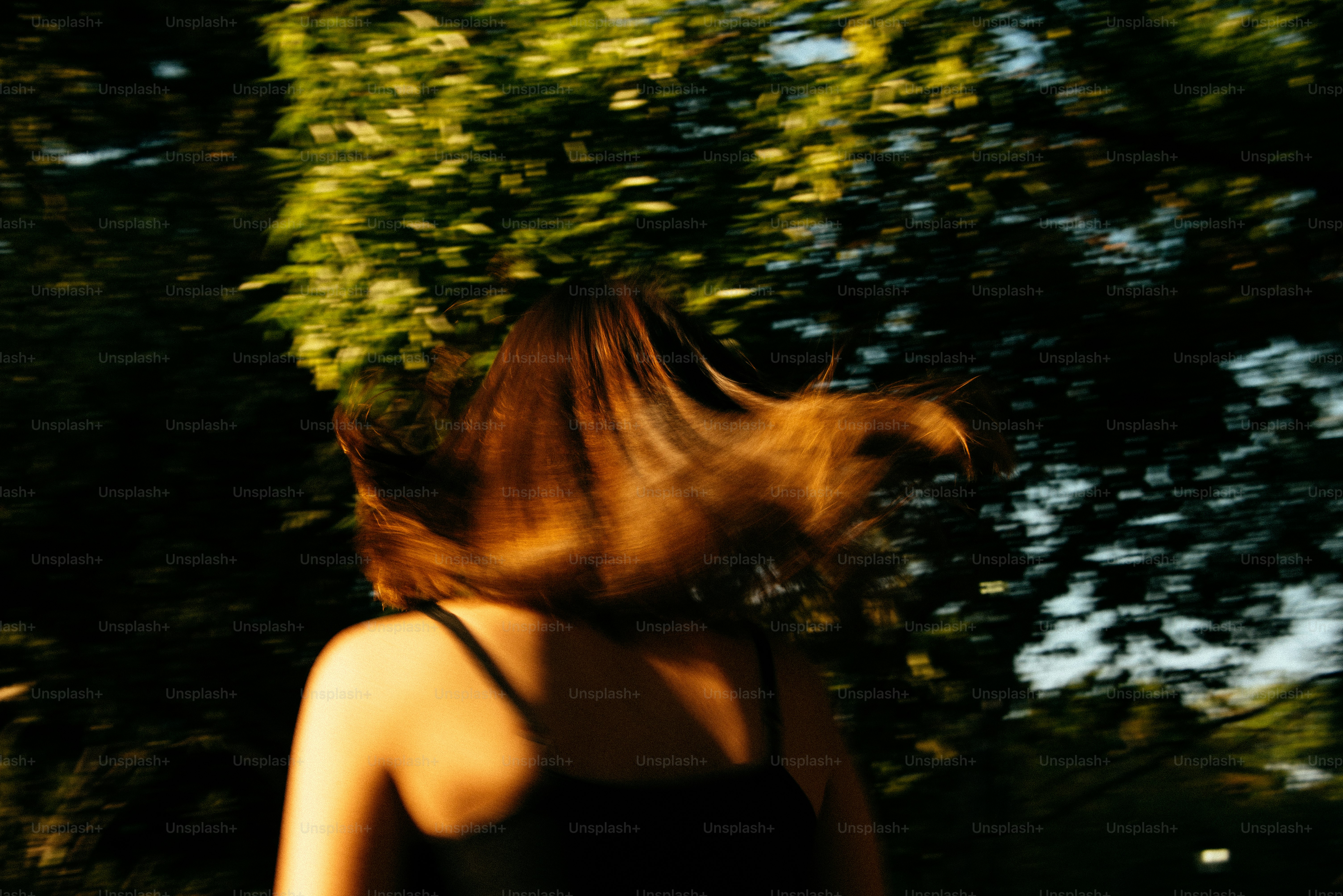 A blurry photo of a woman in a black dress
