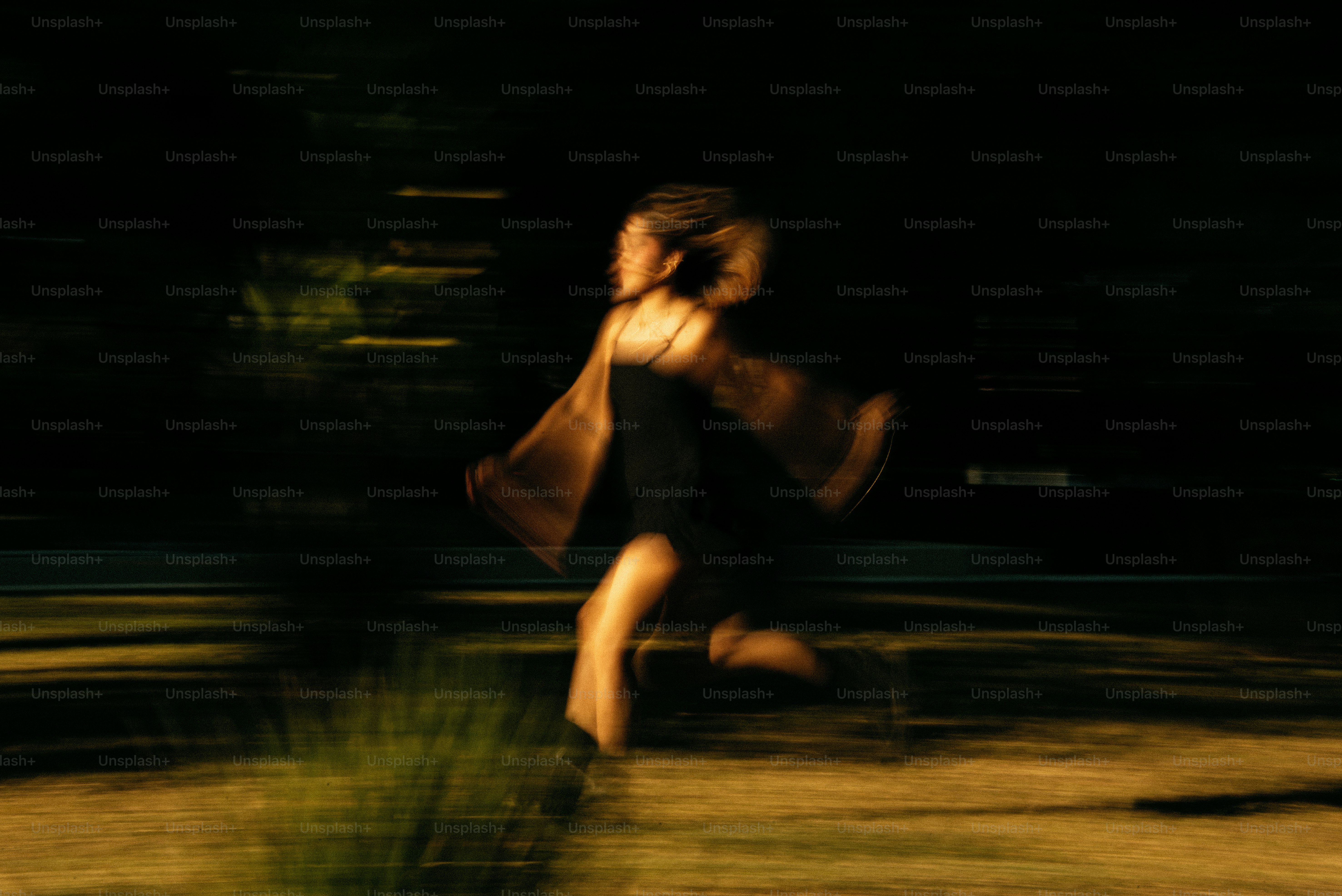 A blurry photo of a woman walking in the dark