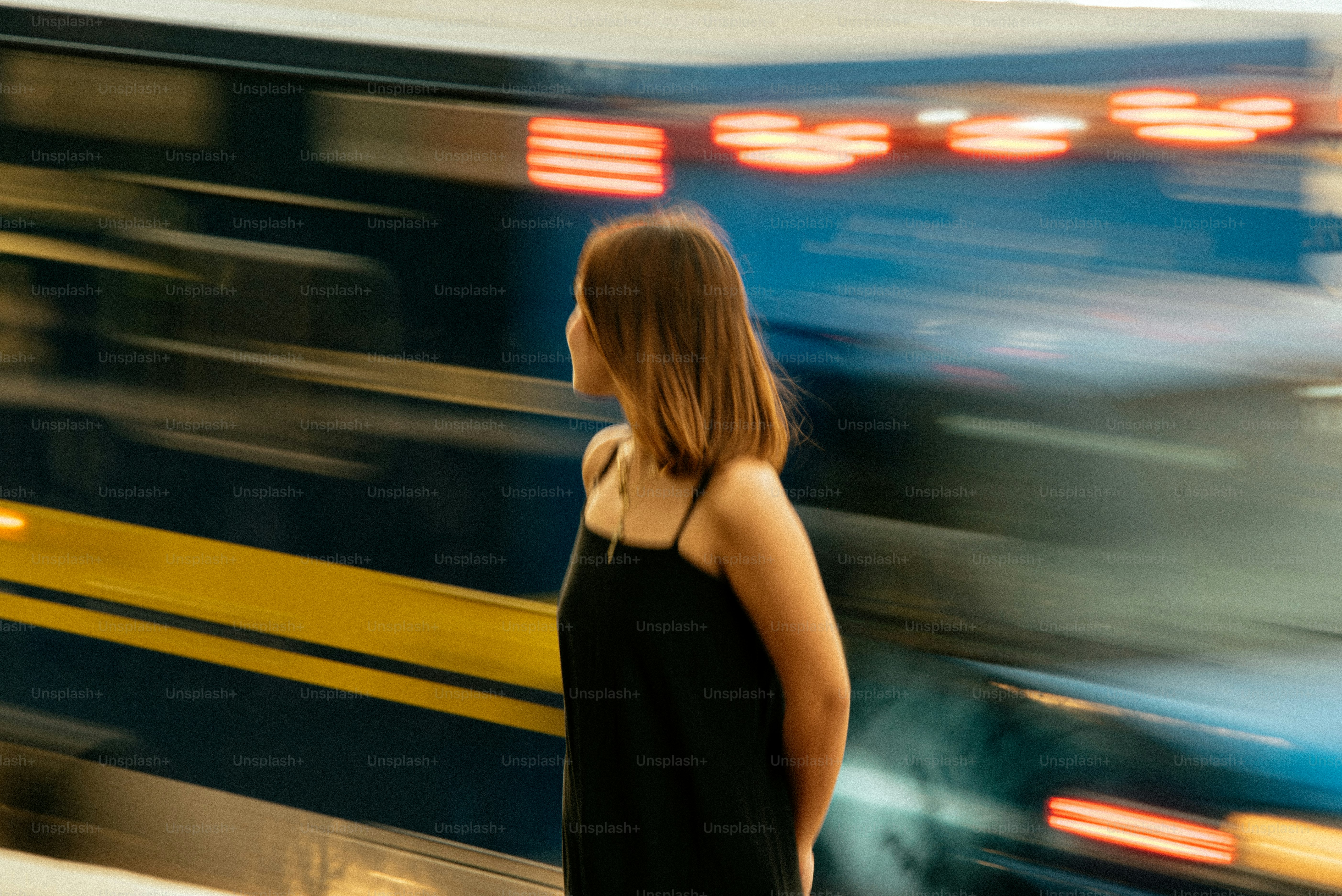 A woman standing in front of a train