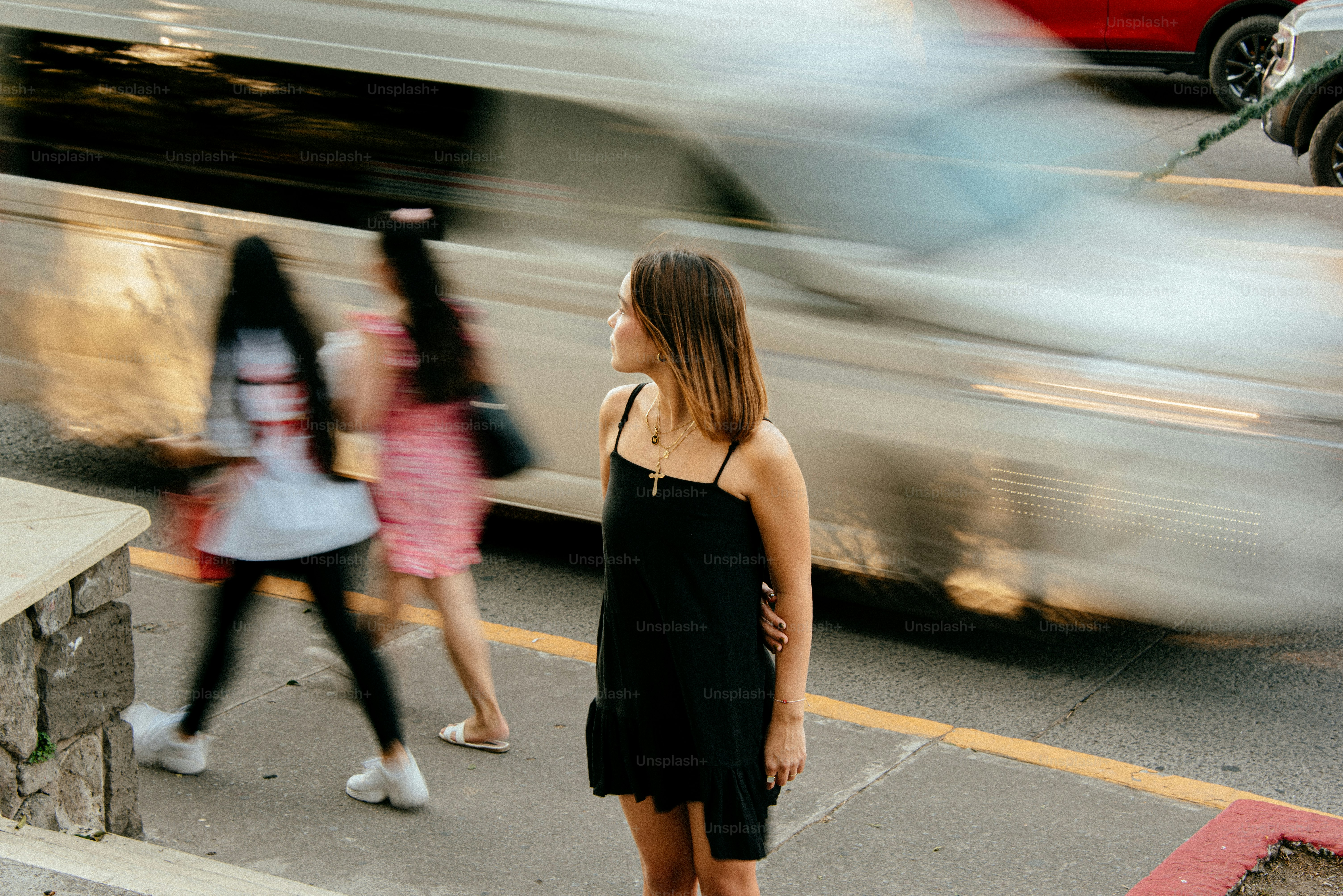 A blurry photo of two women standing on a sidewalk
