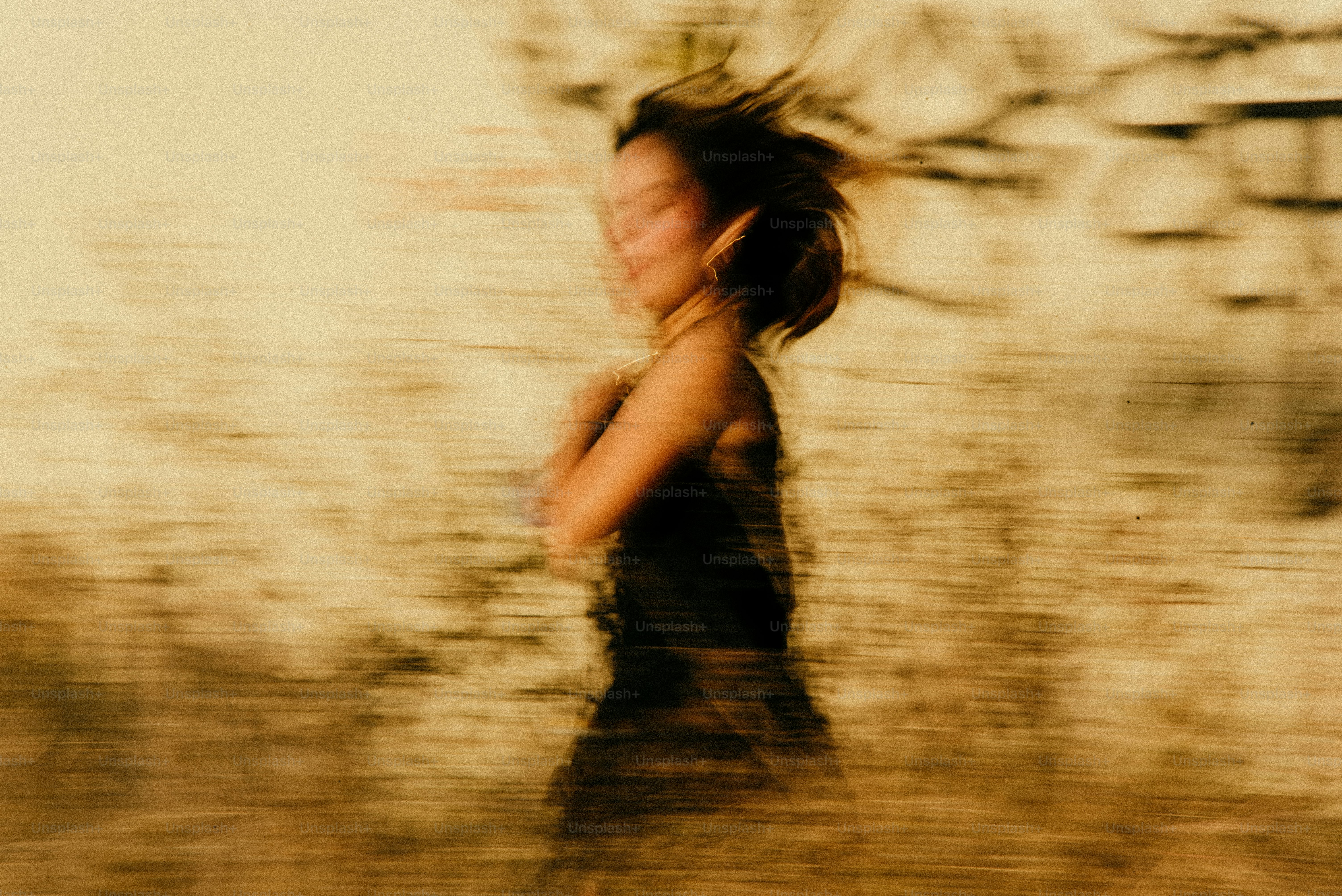 A blurry photo of a woman walking in the grass