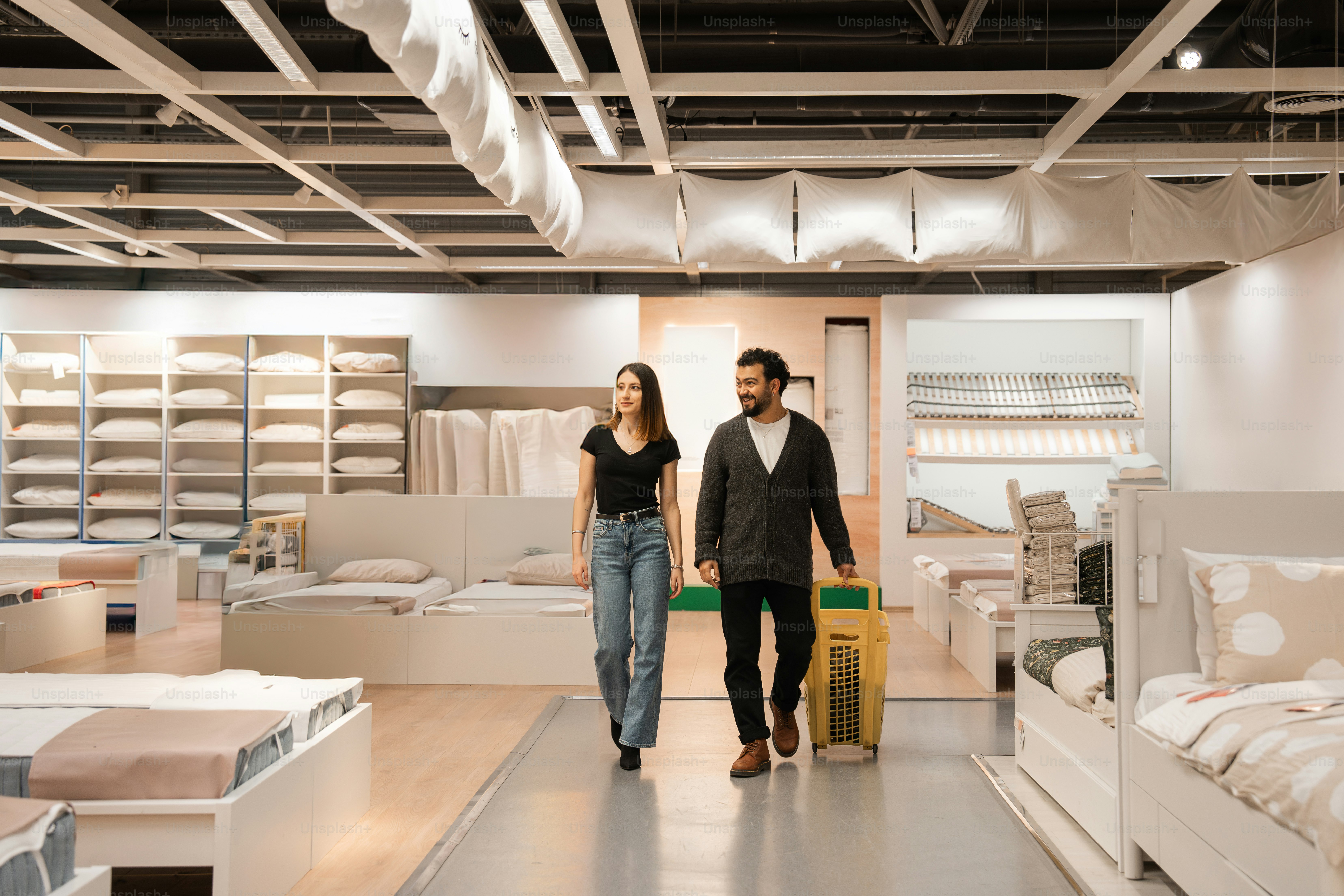 A man and a woman walking through a store