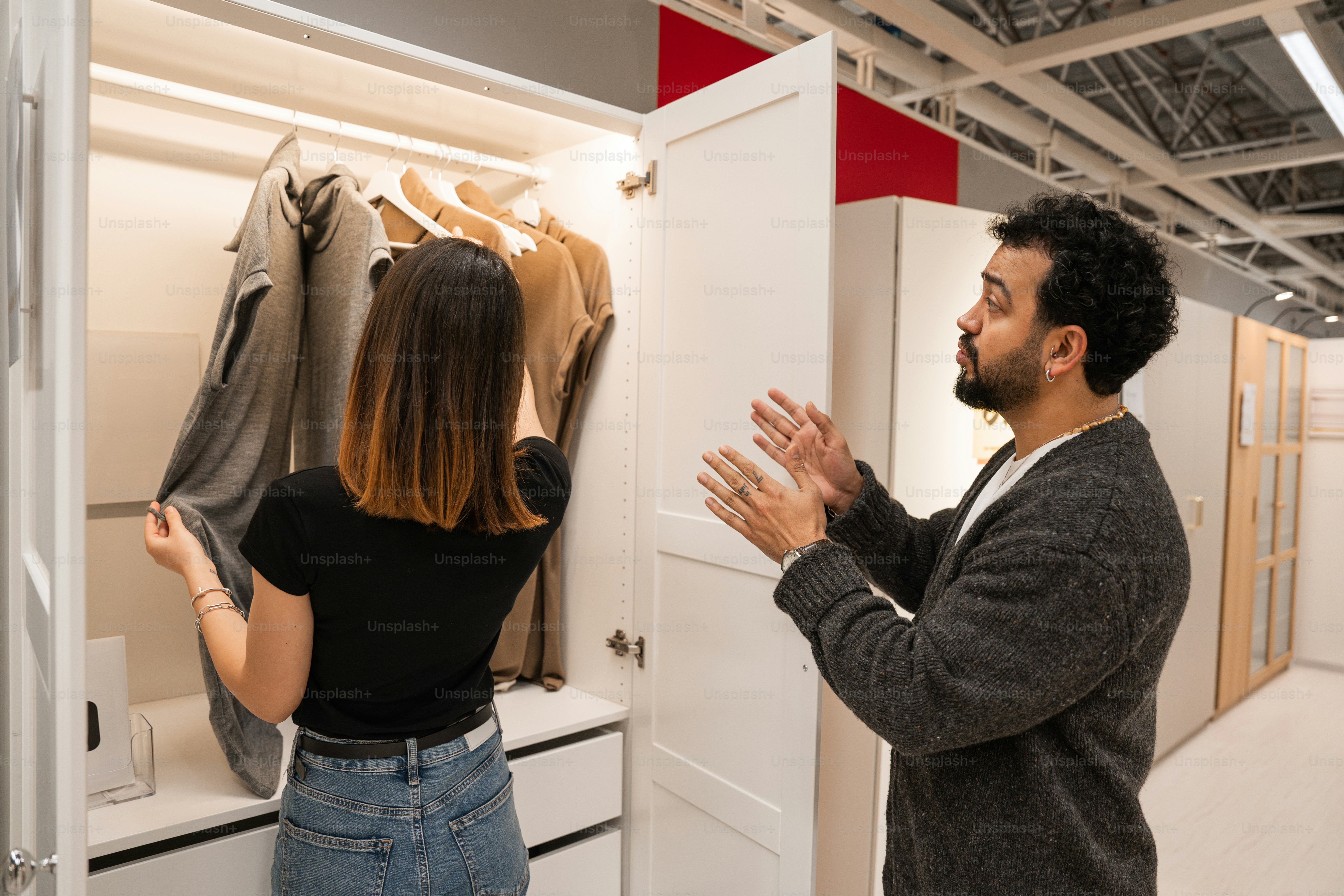 A man and a woman standing in a closet