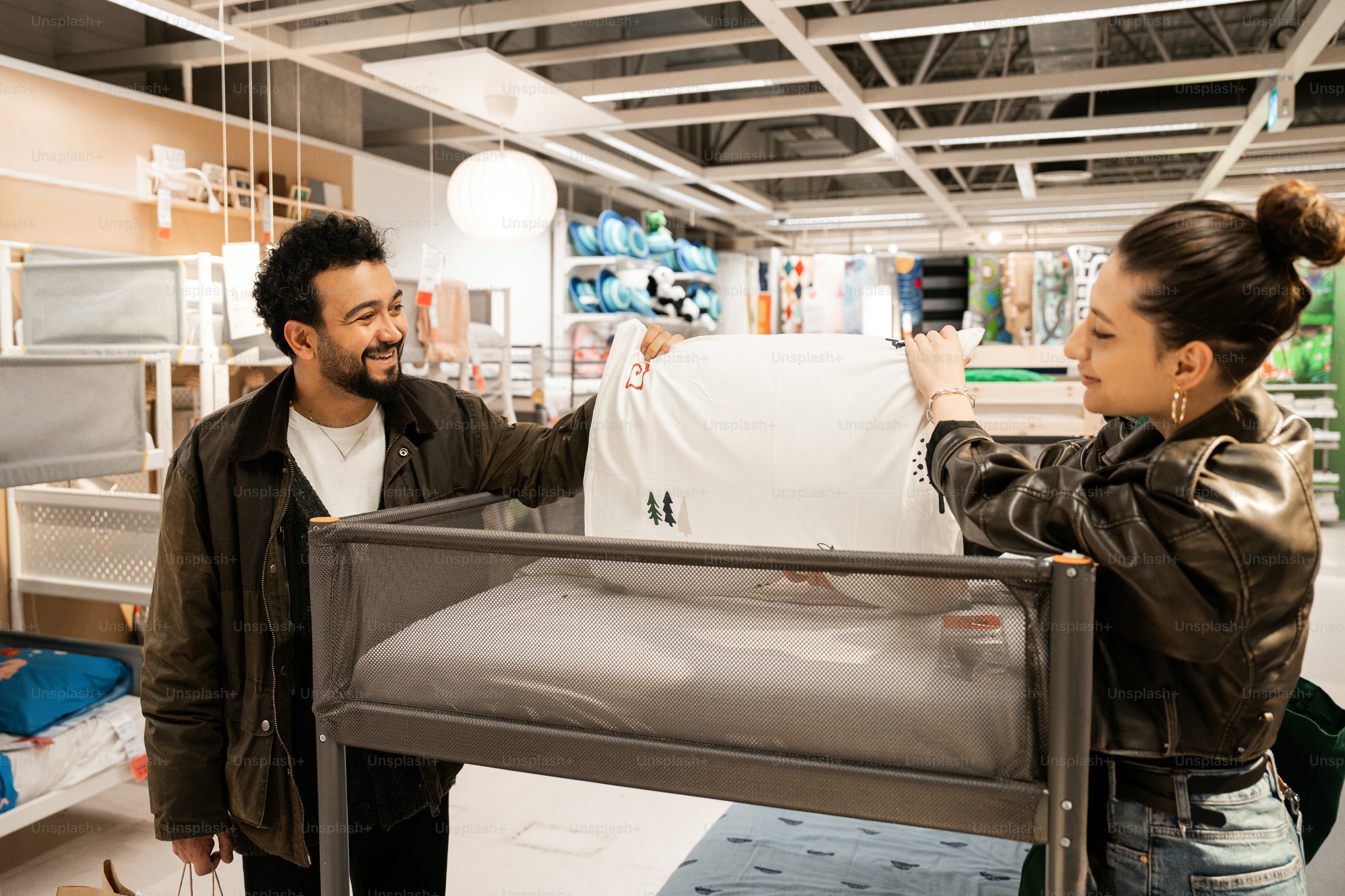 A man and a woman looking at a mattress in a store