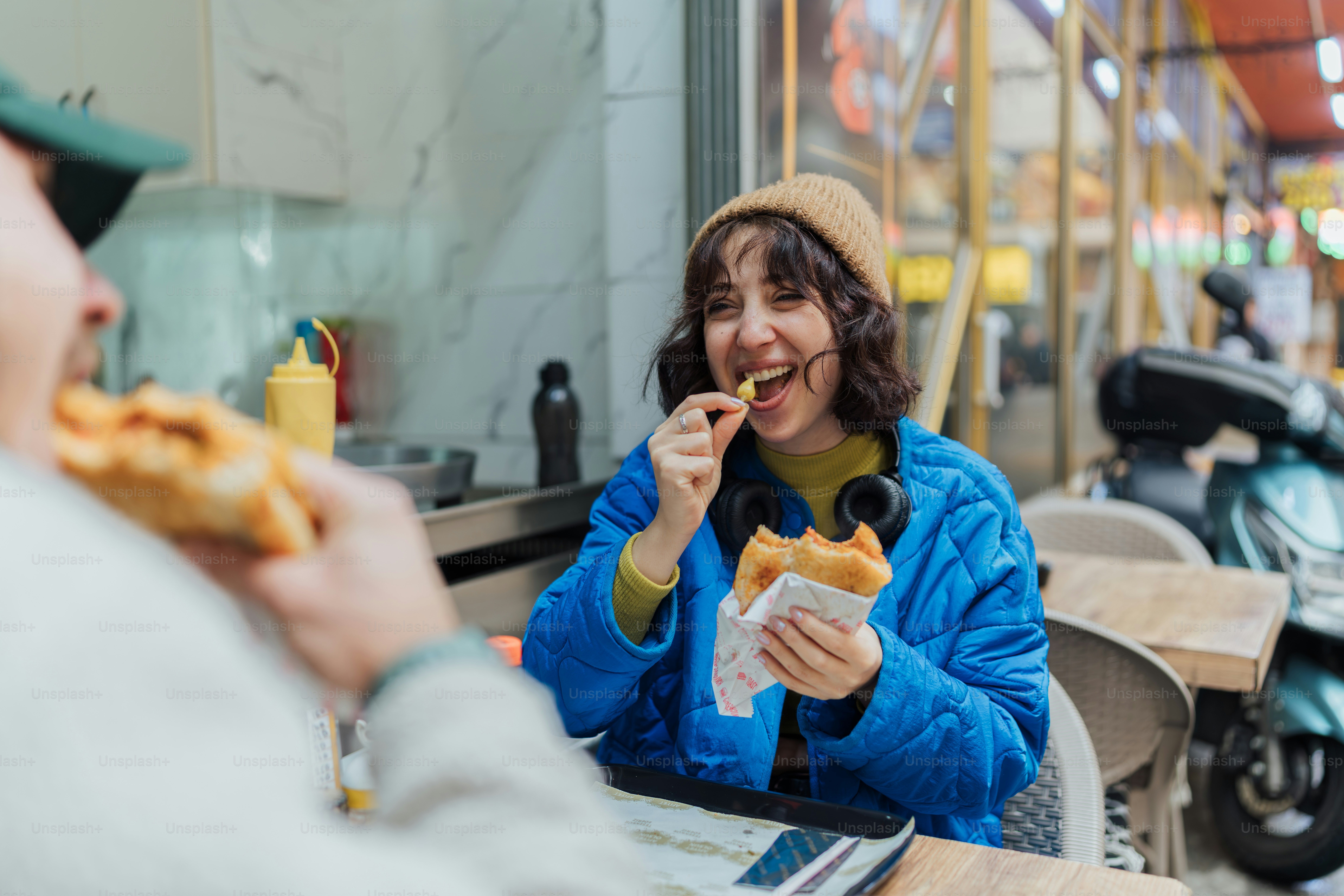 A woman sitting at a table eating food