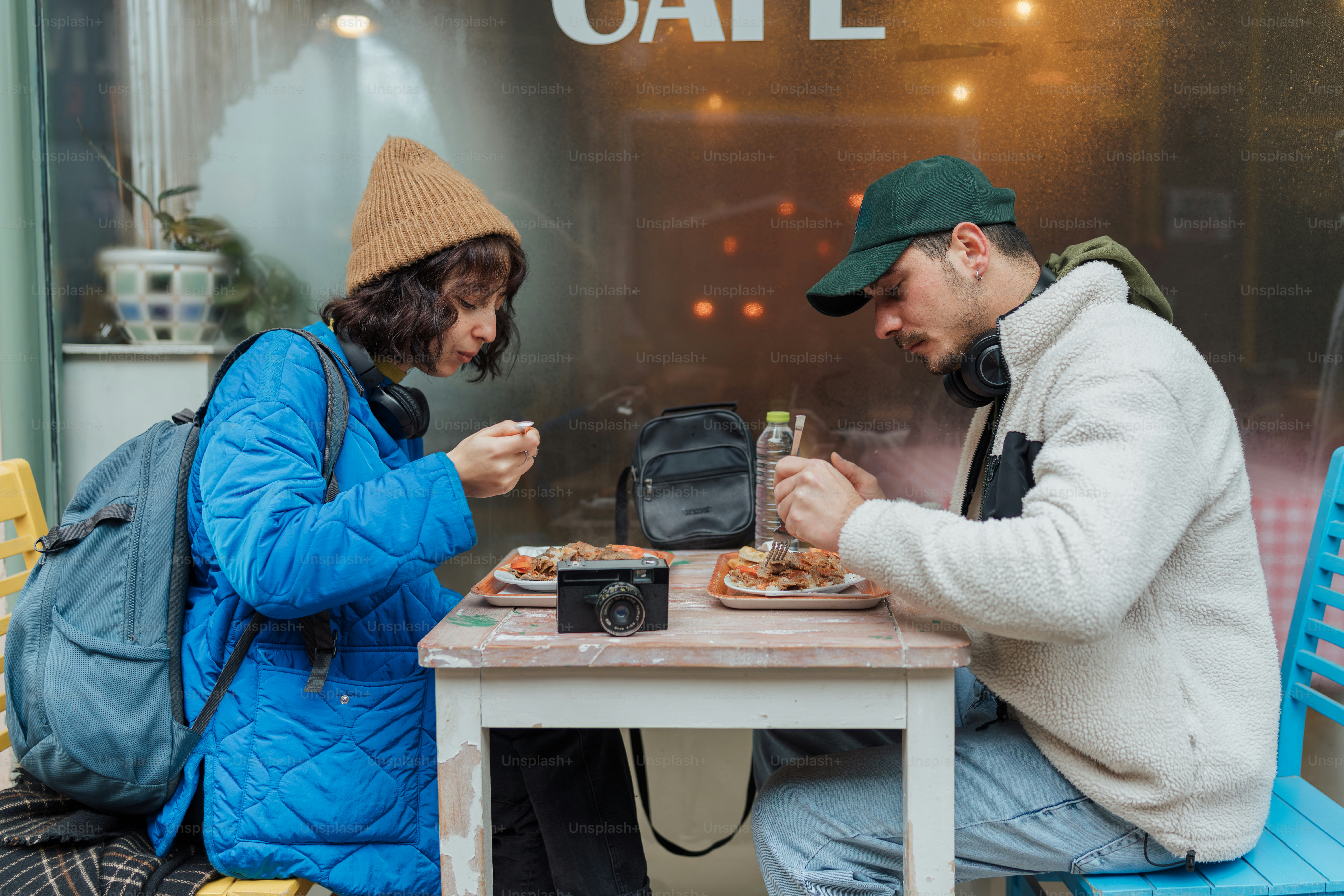 A man and a woman sitting at a table eating