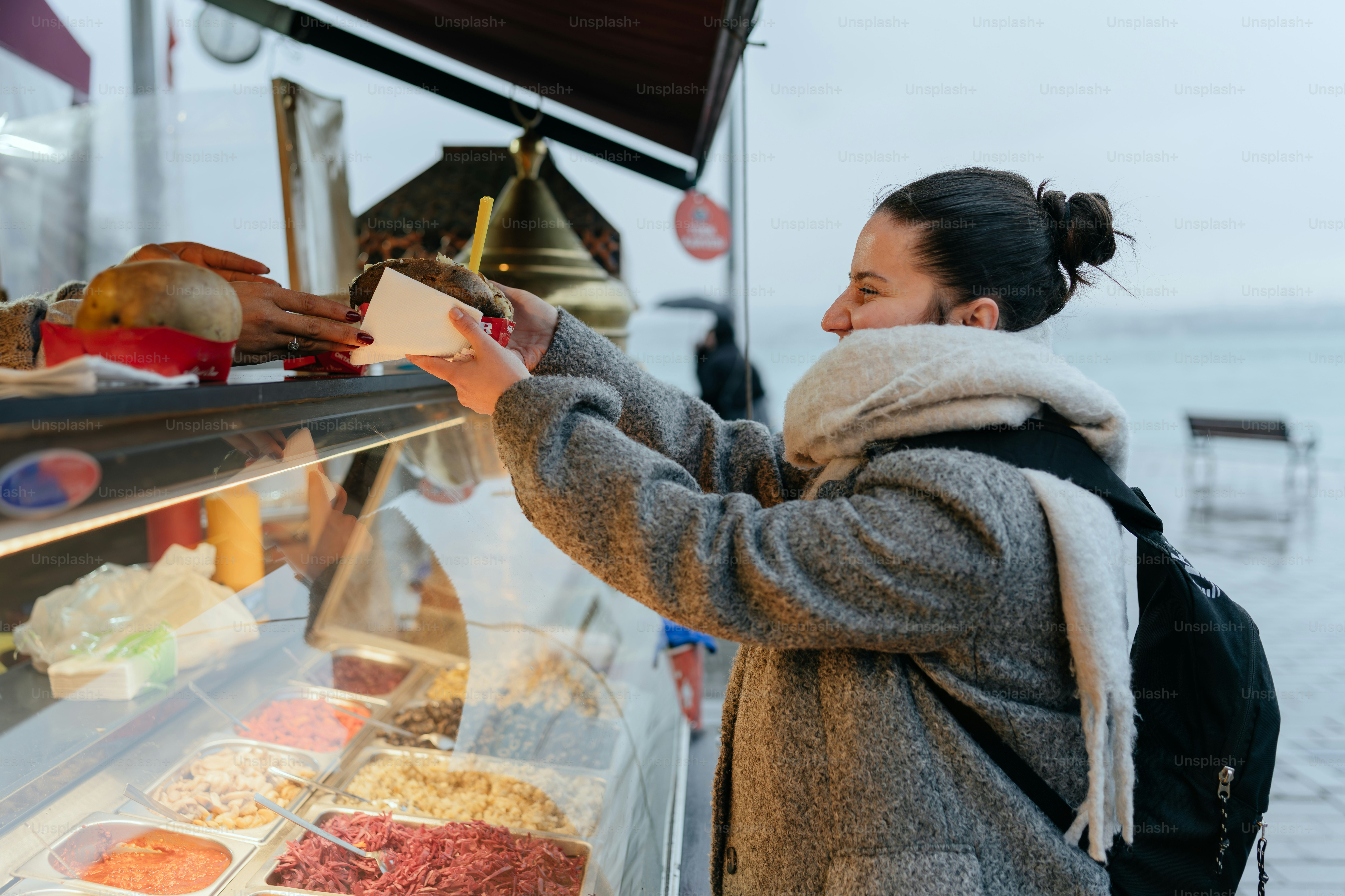 A woman standing in front of a display of food