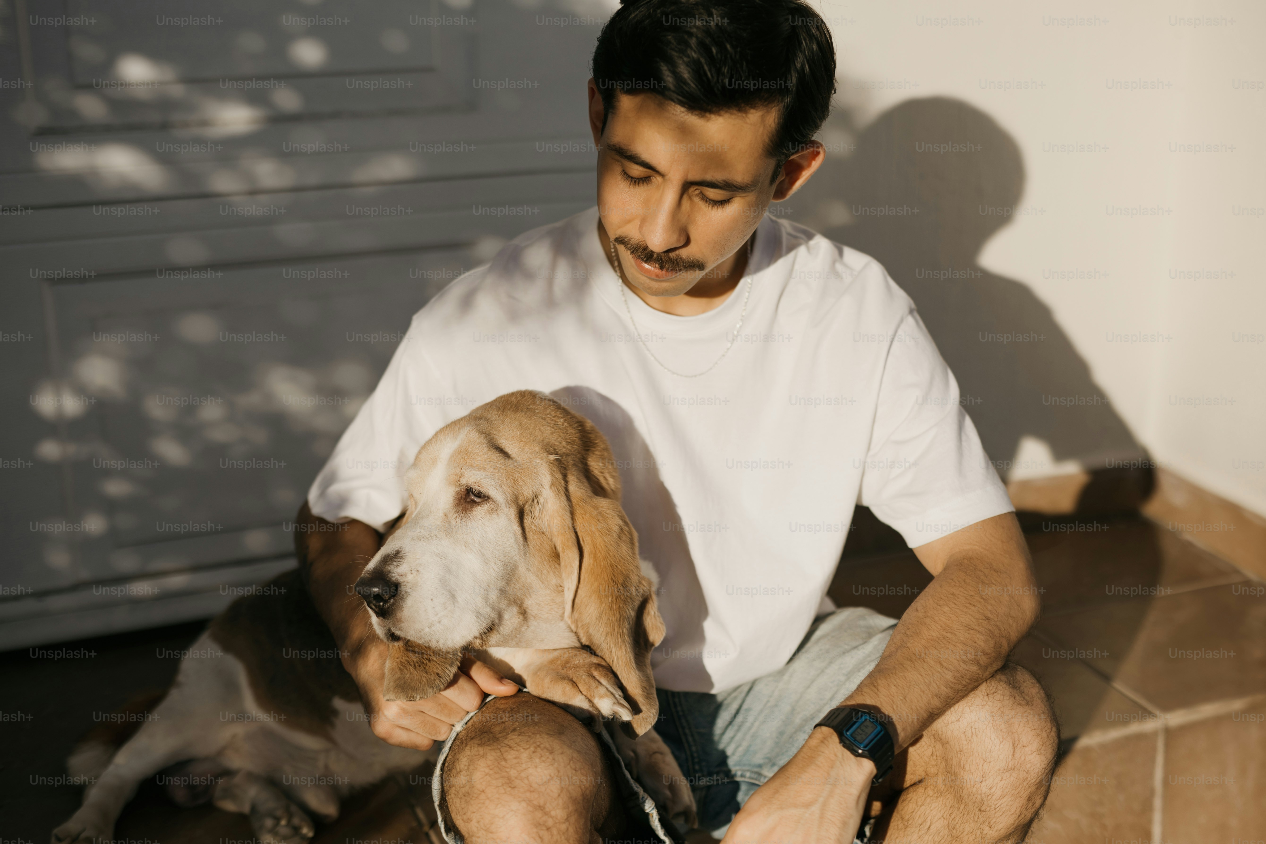 A man sitting on the floor with a dog
