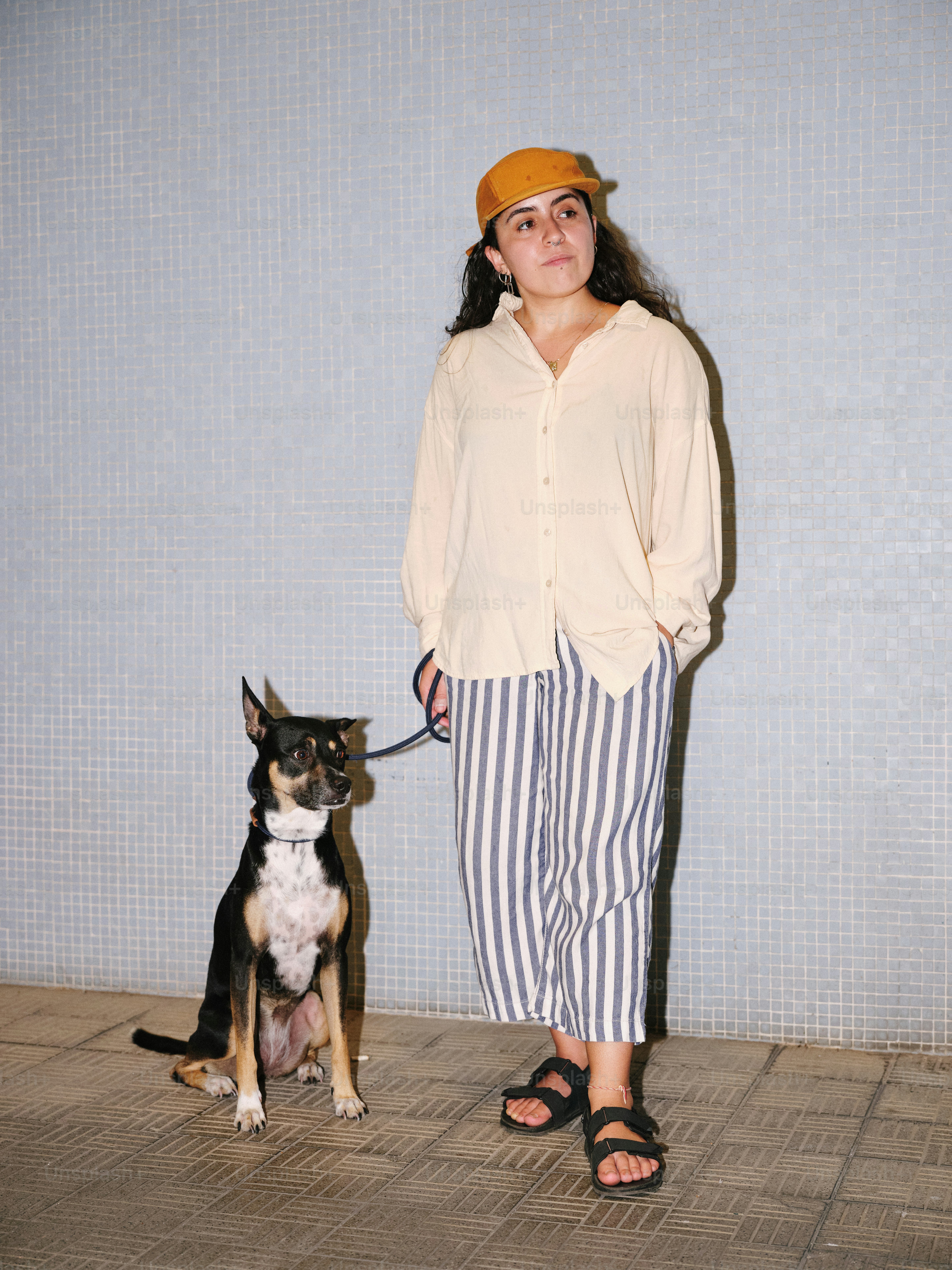 A woman standing next to a dog on a leash photo – Dog Image on Unsplash