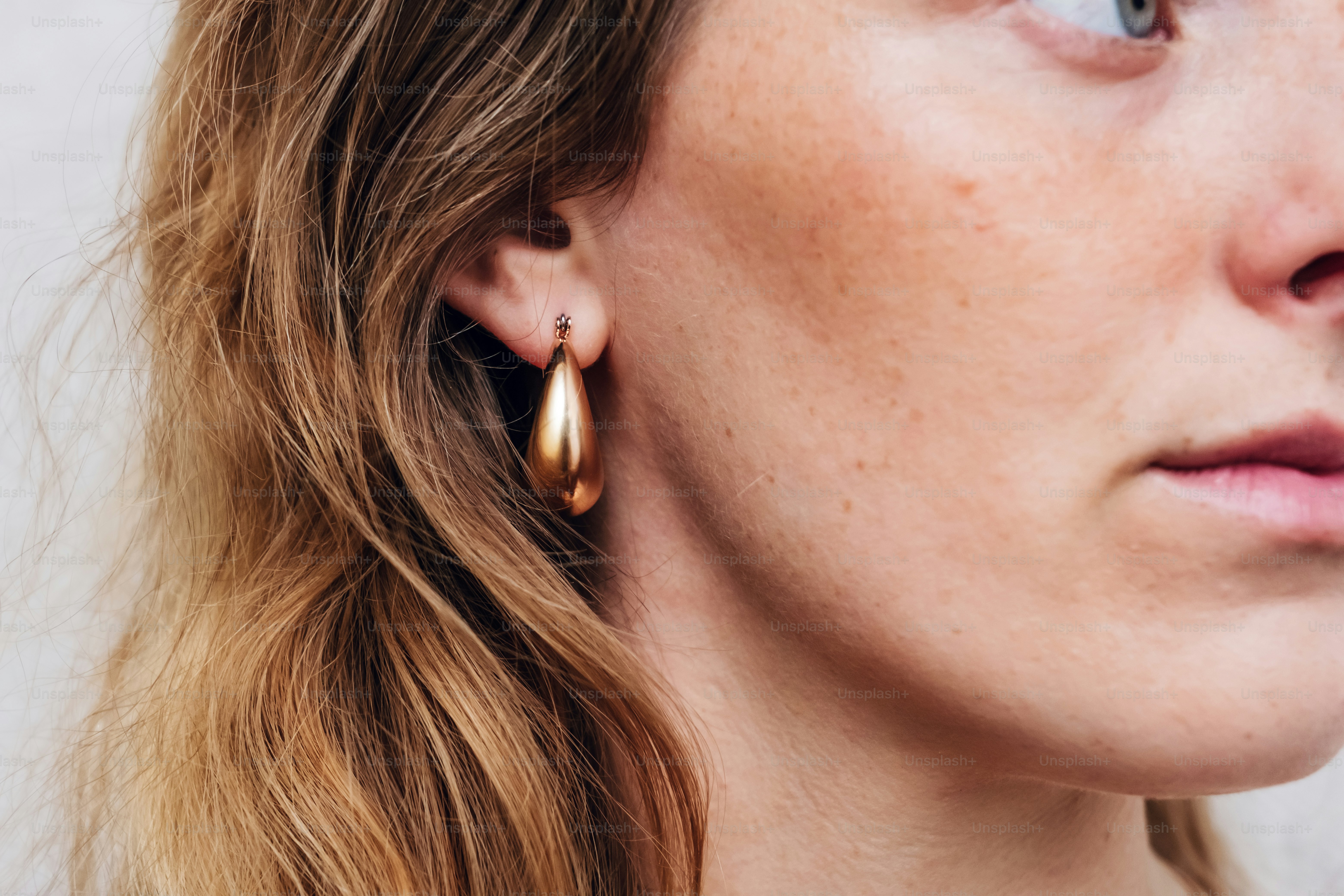 A close up of a person wearing earrings