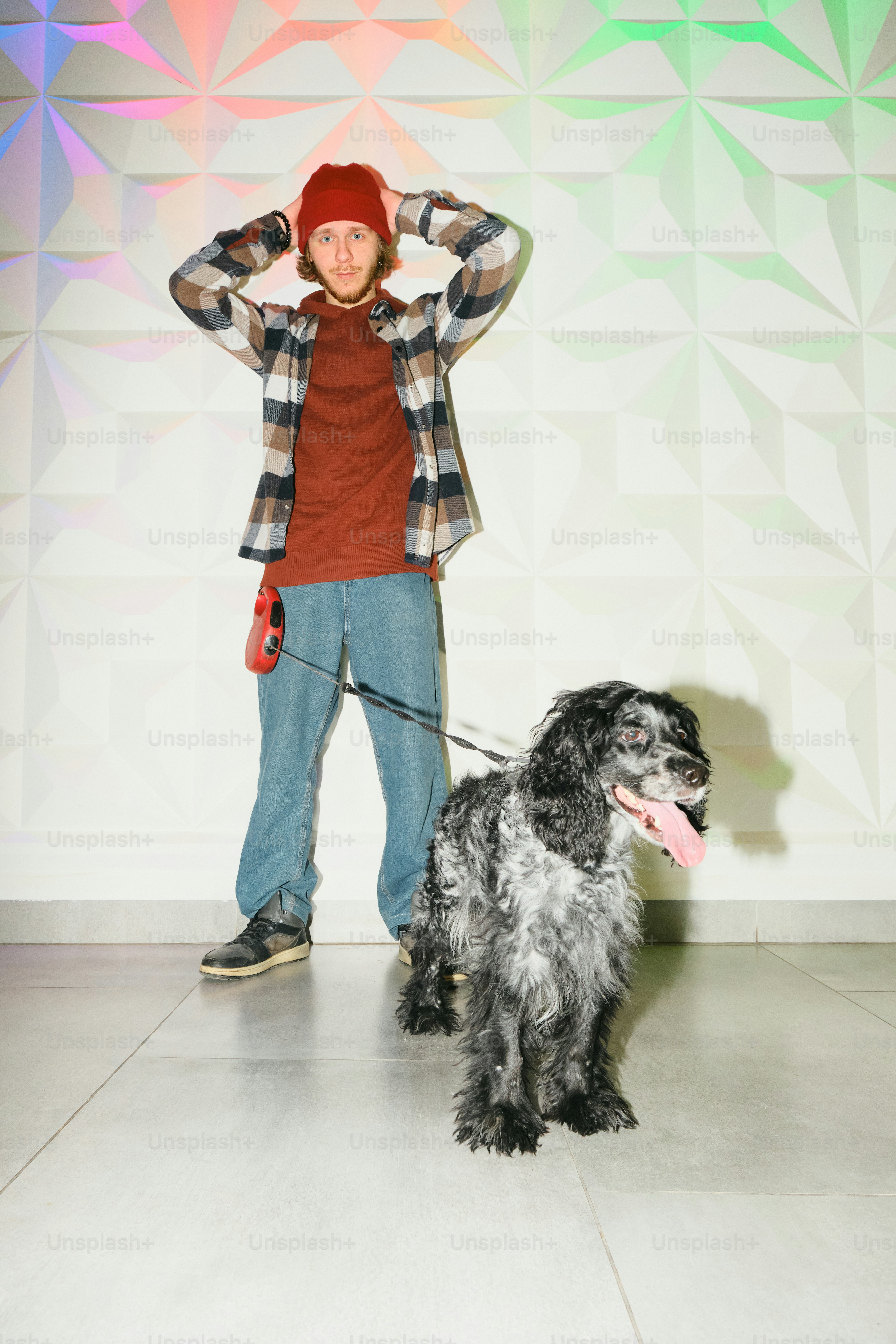 A man standing next to a dog on a leash