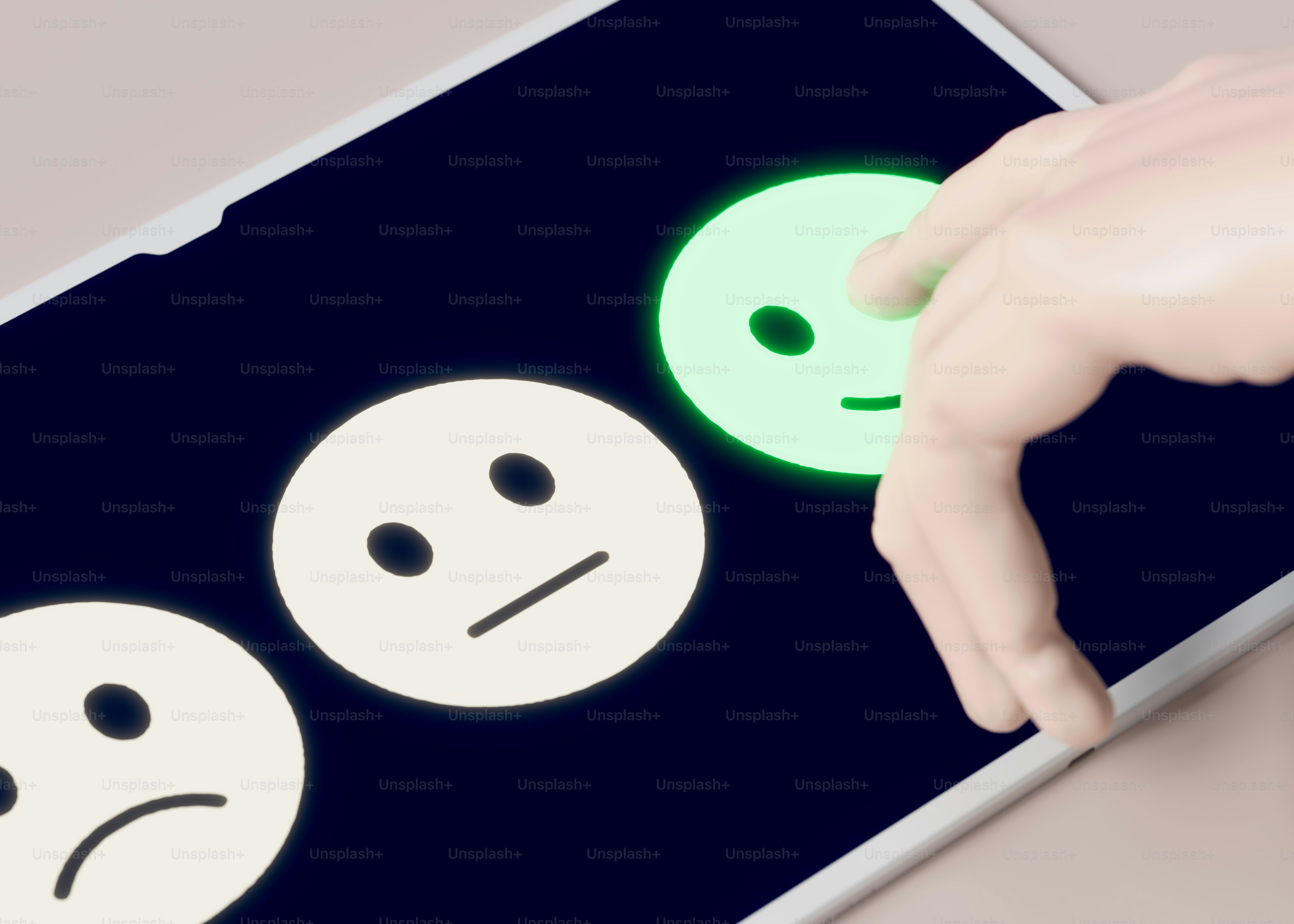A hand touching a tablet with a smiley face on it