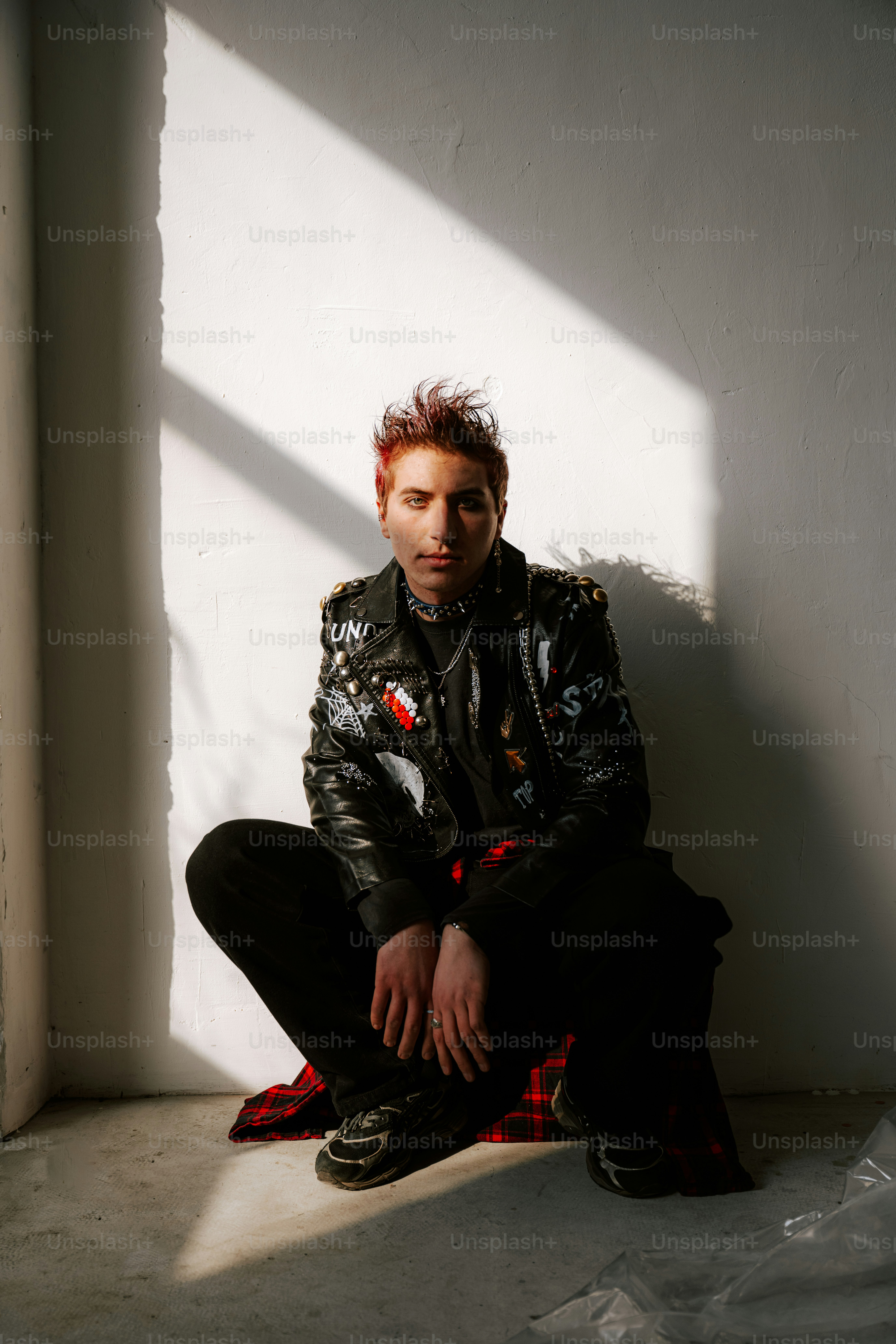 A man sitting on the ground in a room