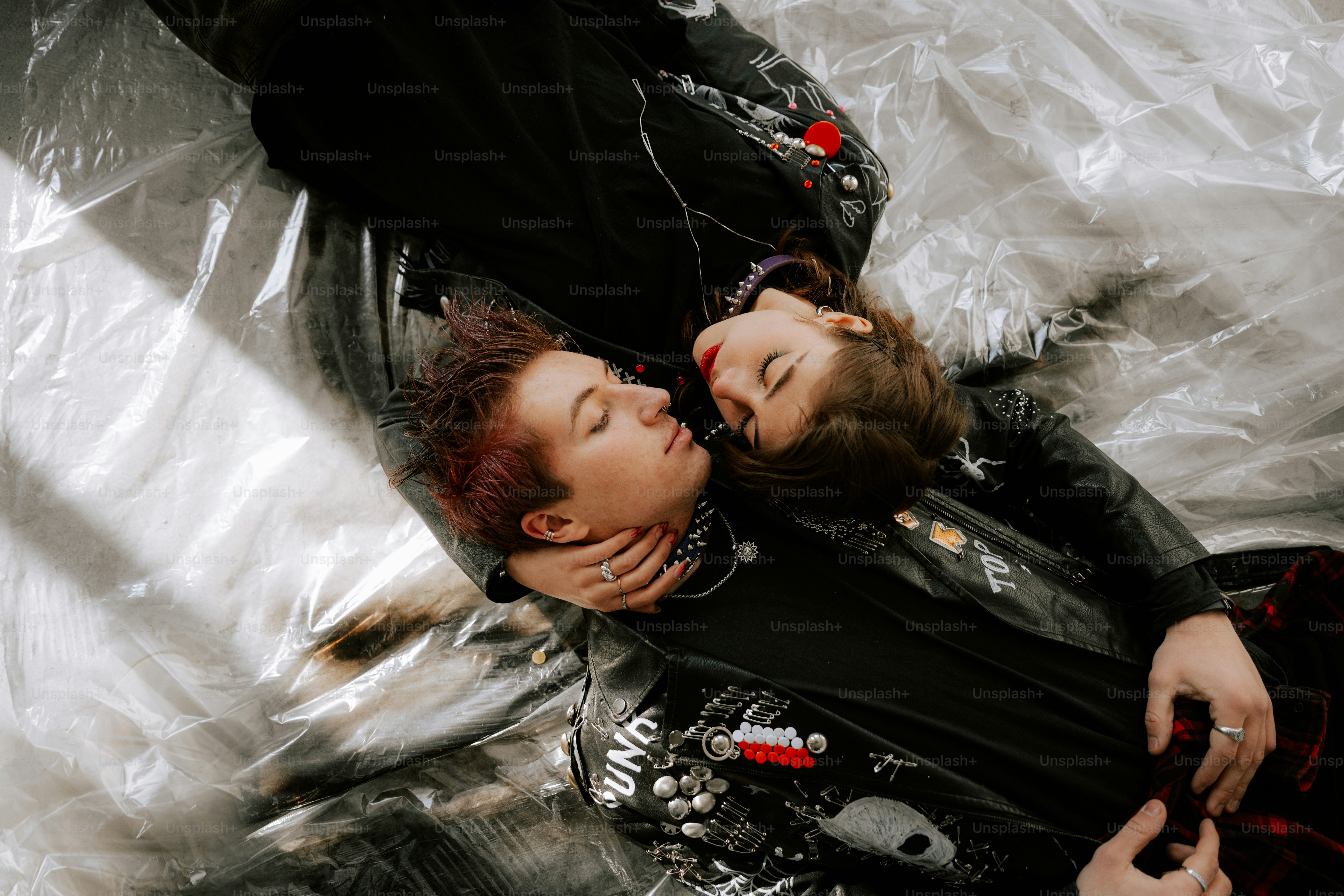 A couple of people laying on top of a bed