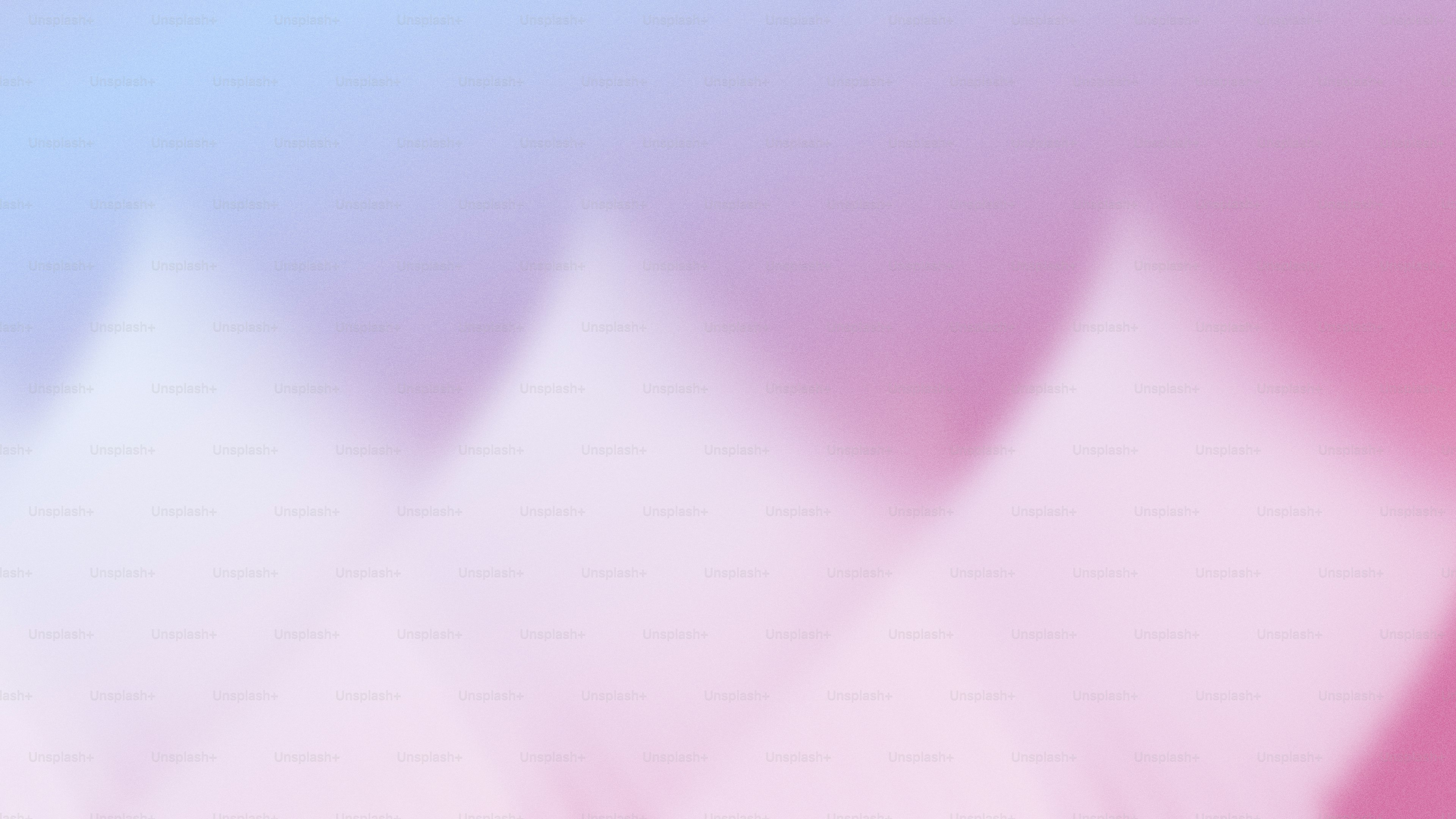 A blurry image of a pink and blue background