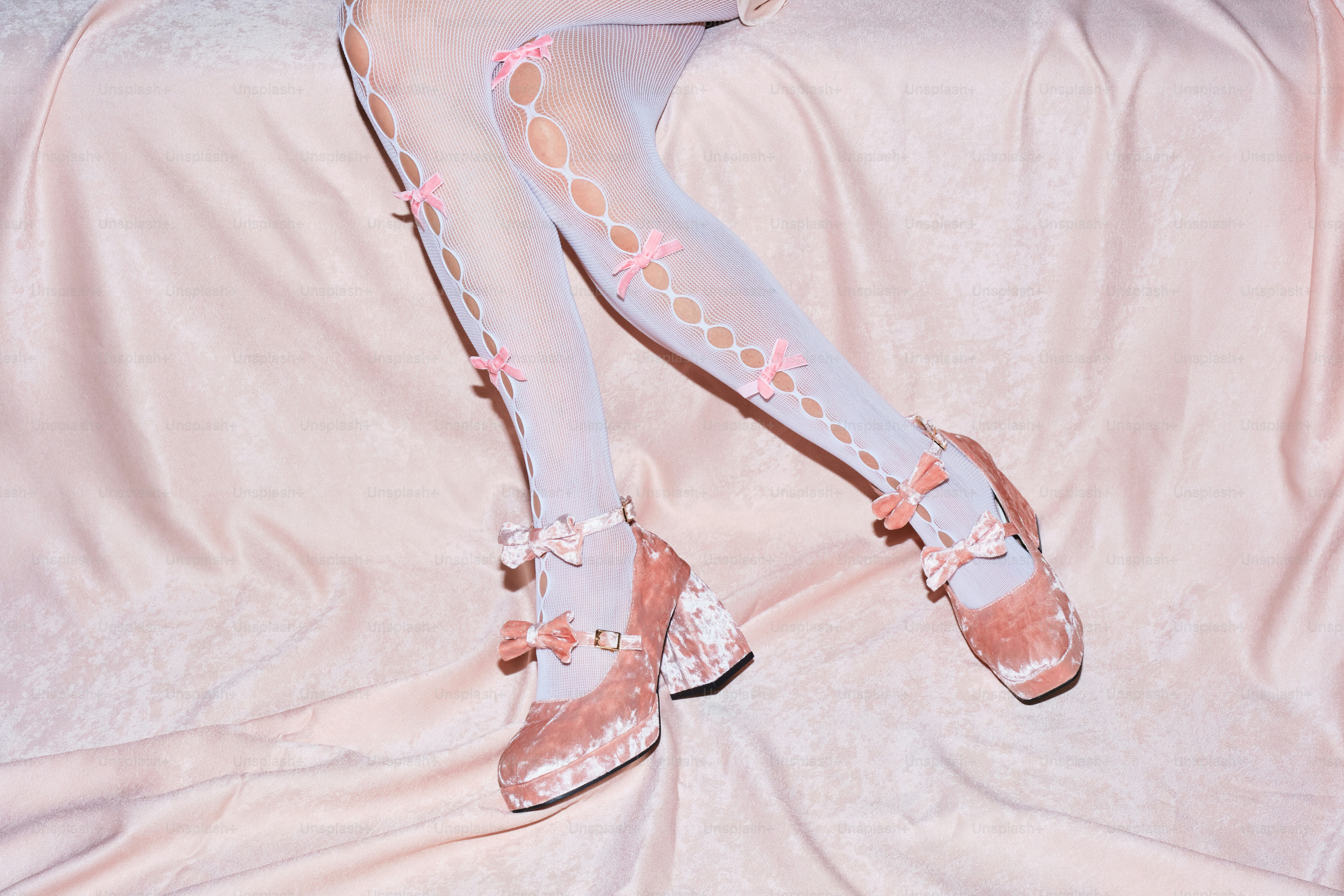 A doll sitting on top of a white sheet