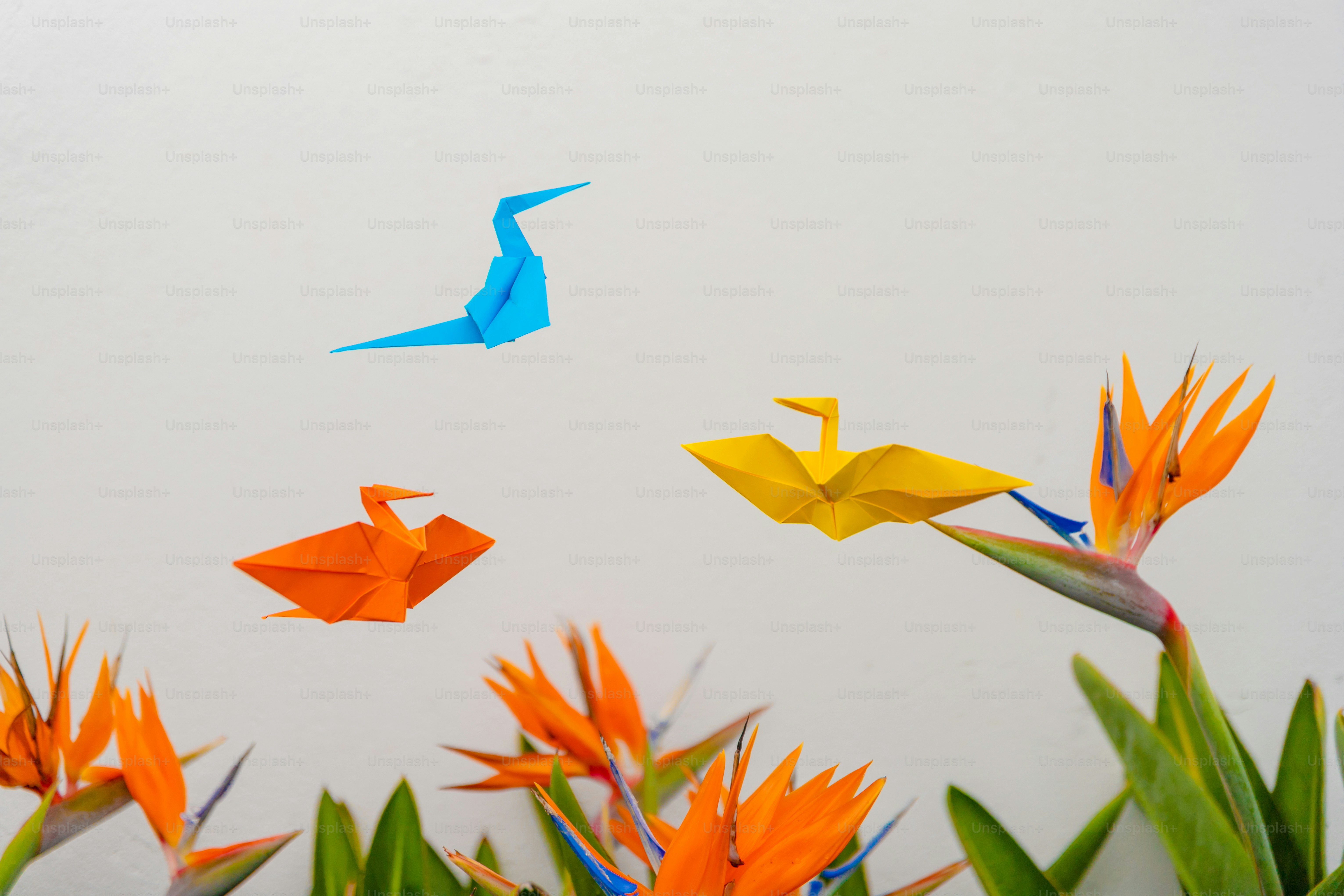 A group of origami birds flying in the sky
