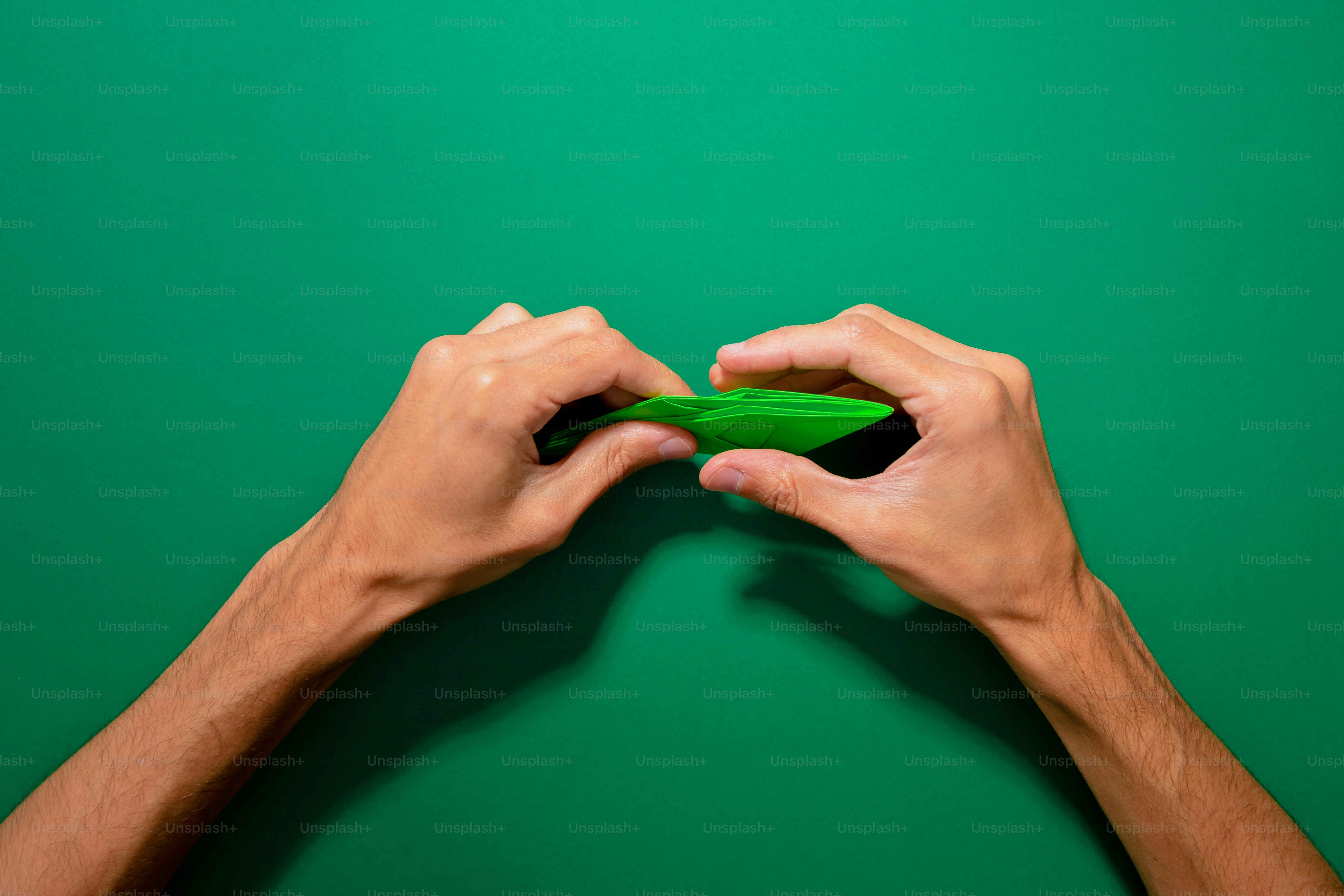 A person holding a green object in their hands