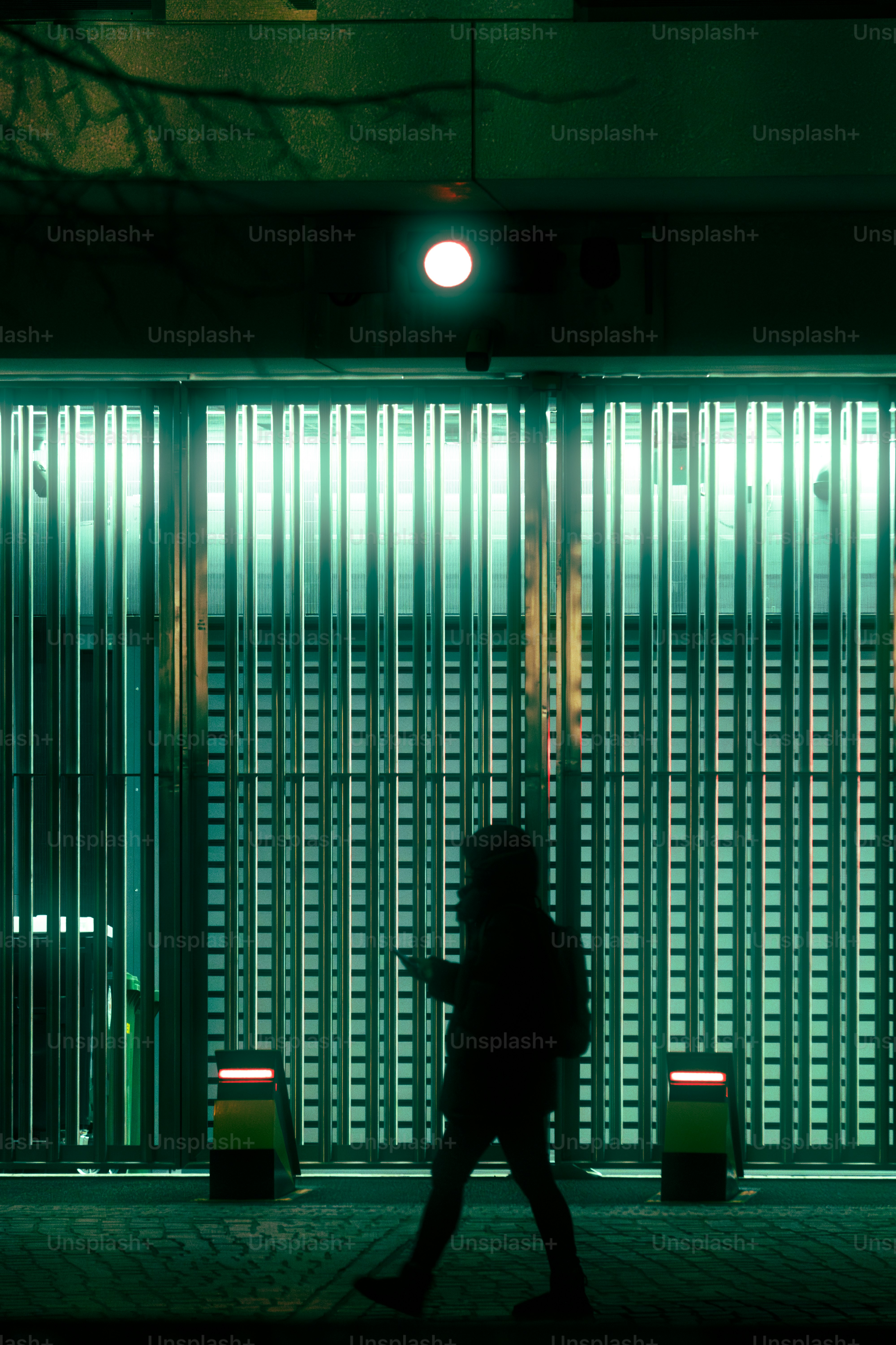 A person walking down a street at night