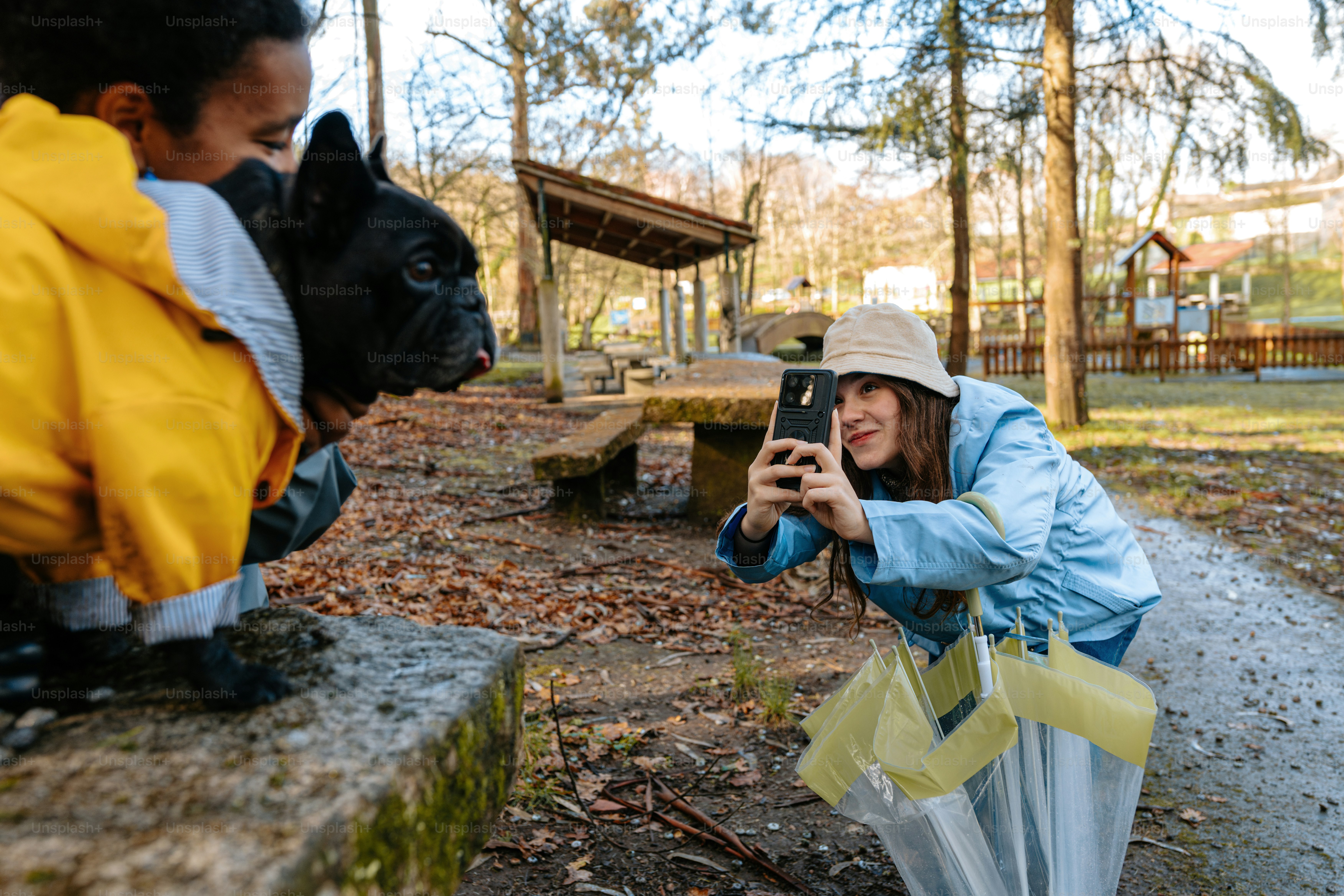 A woman taking a picture of a statue of a dog