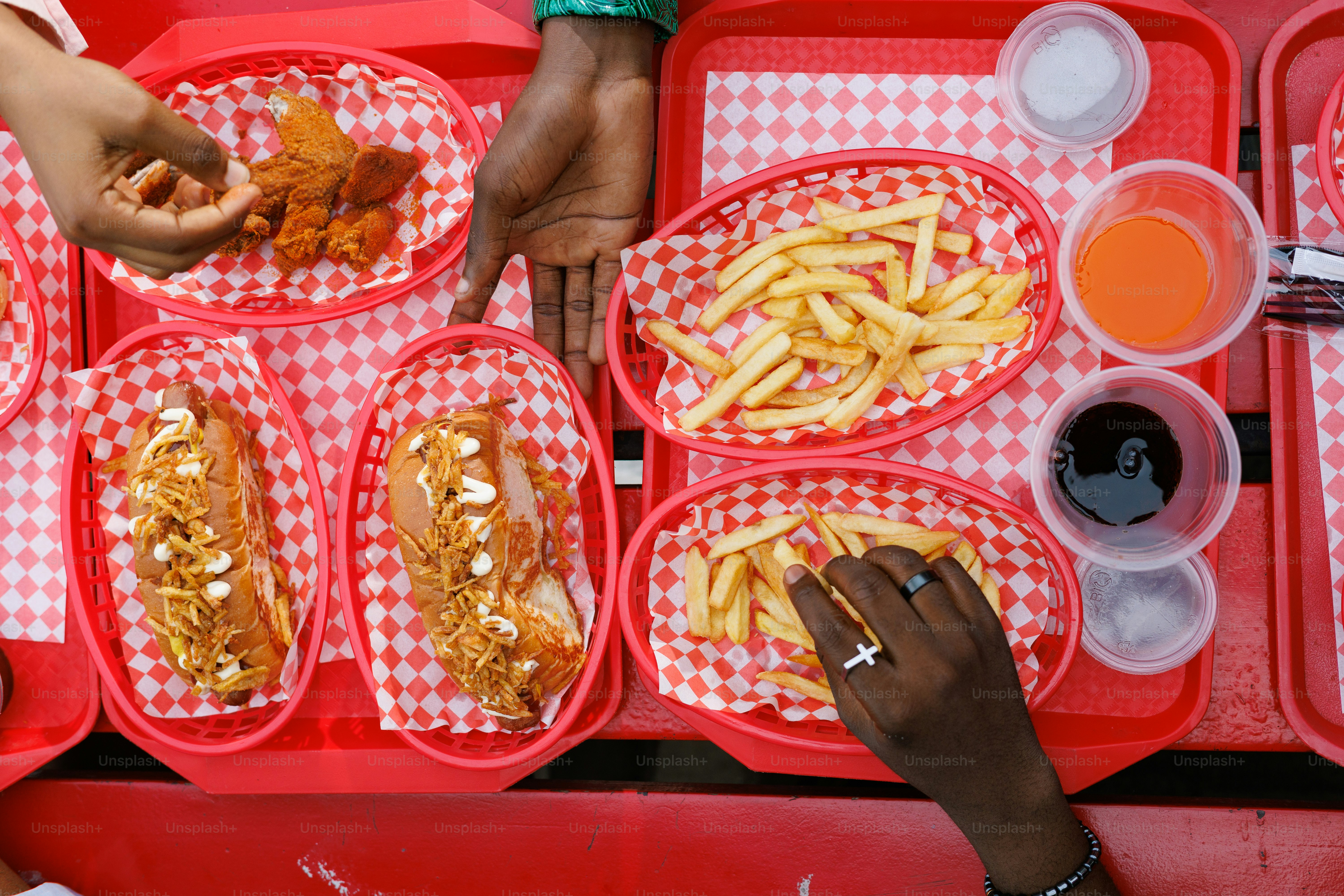 A group of people sitting at a table with trays of food