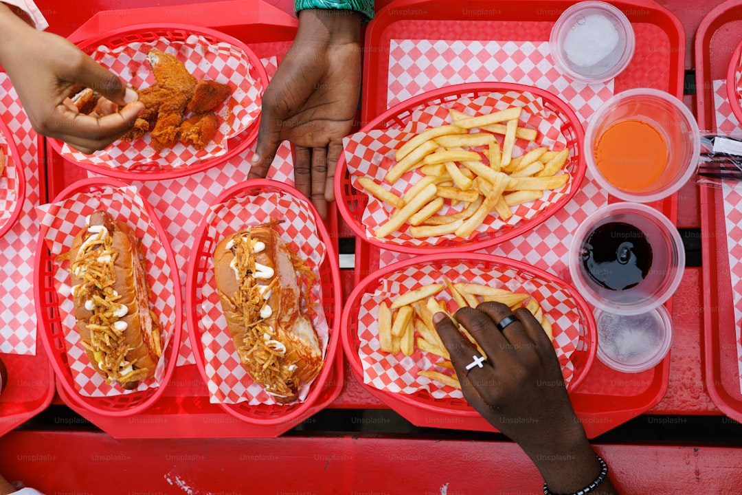 A group of people sitting at a table with trays of food