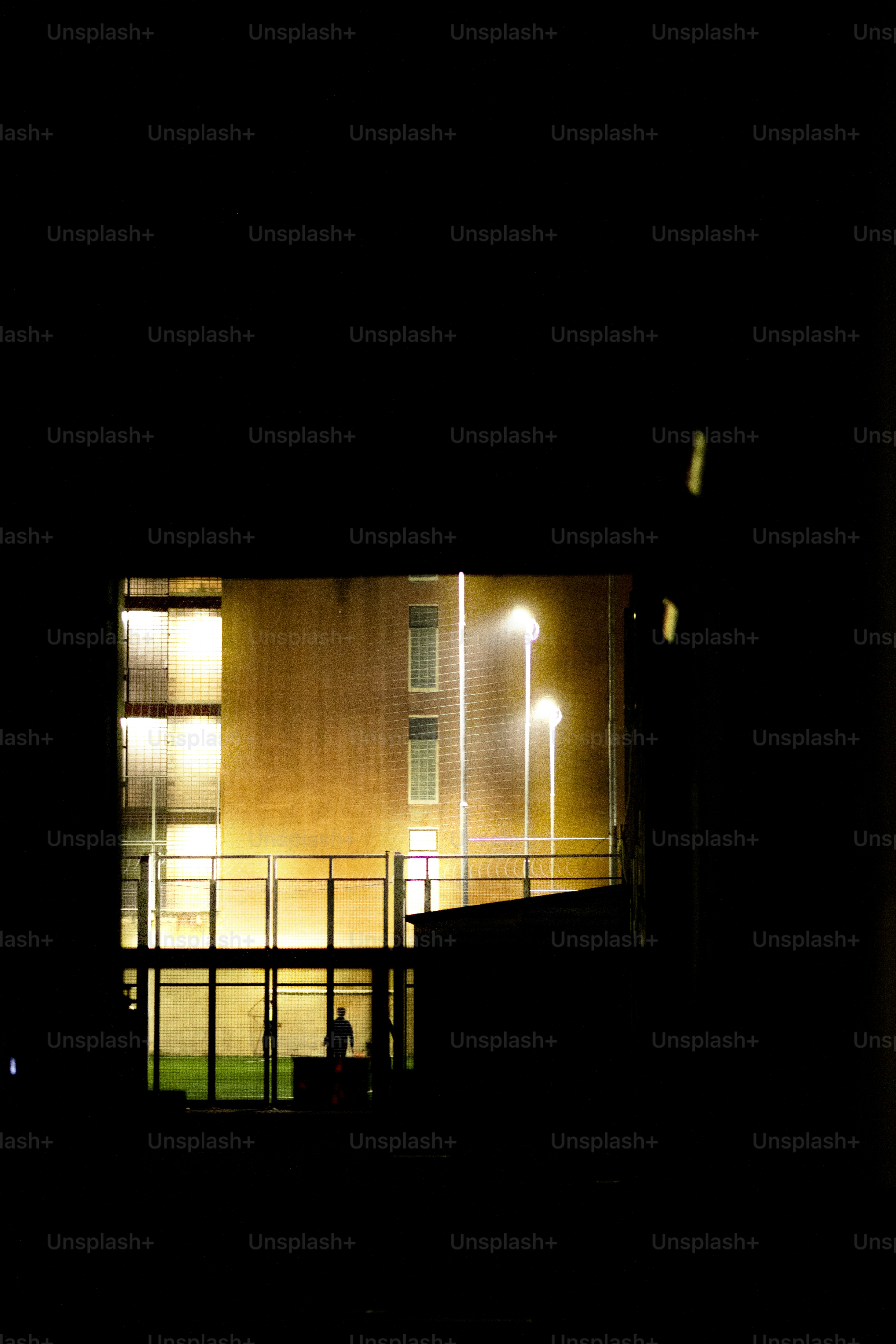 A building lit up at night with street lights