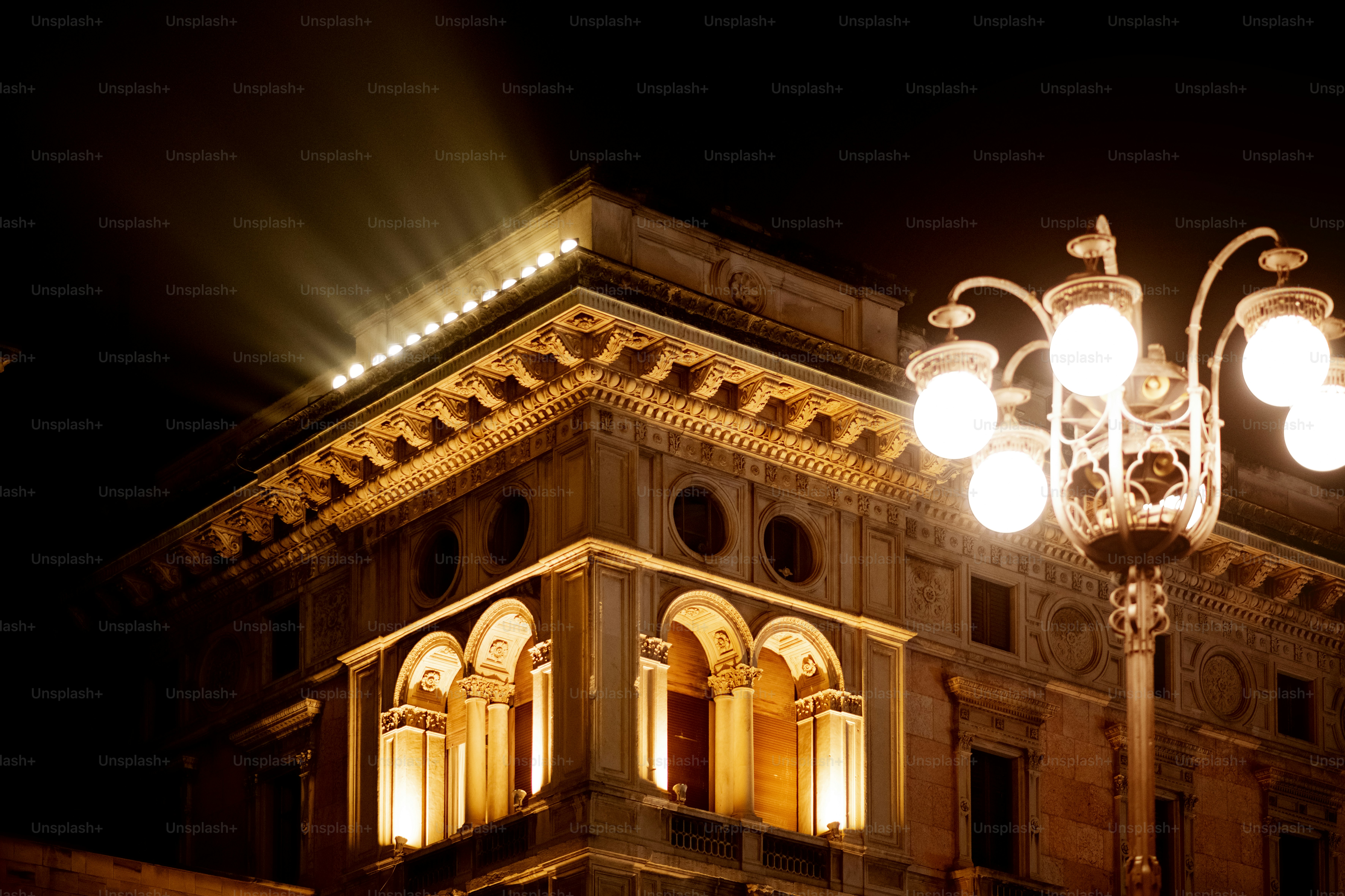 A street light in front of a building at night