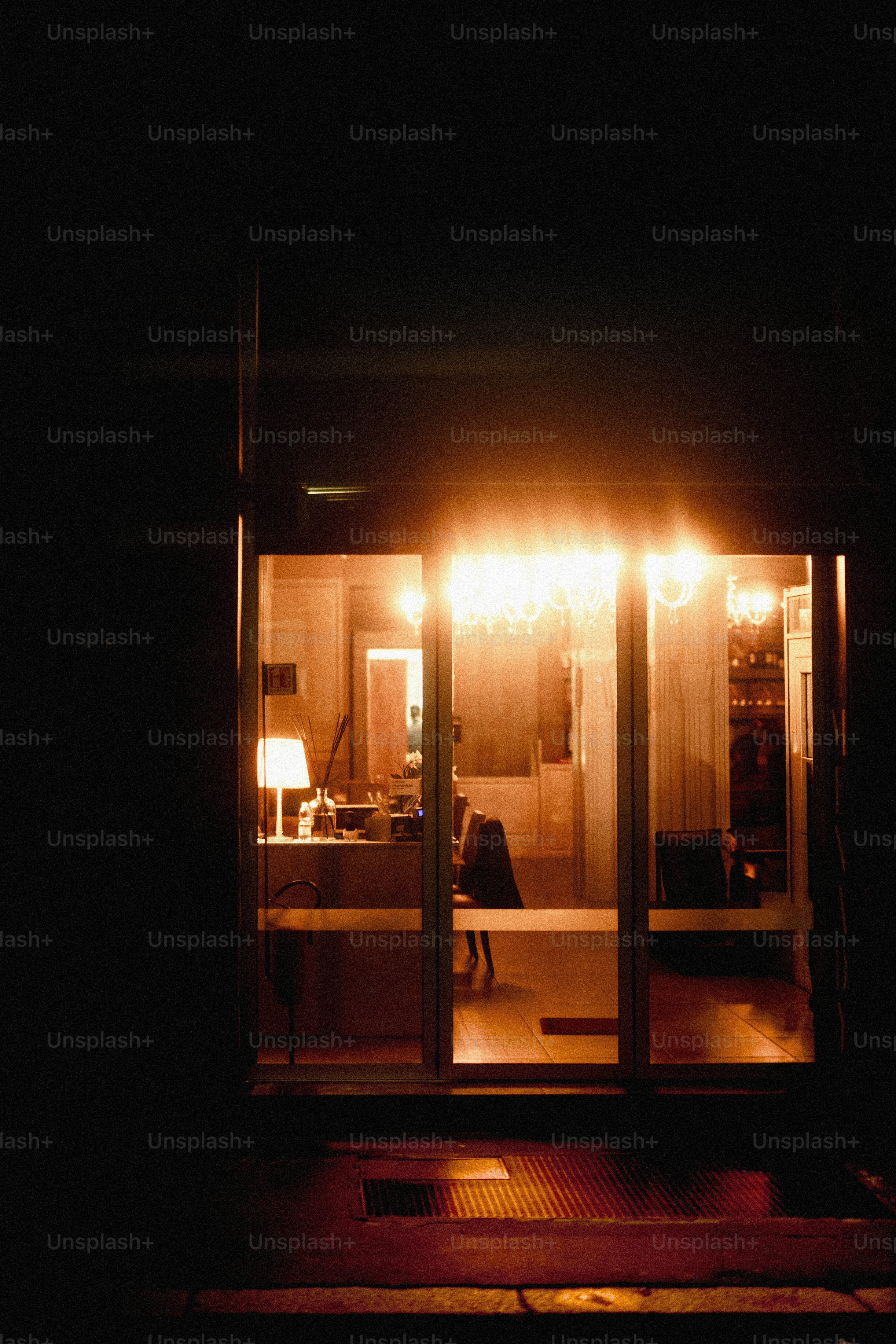 A dark room with a table and a lamp in it