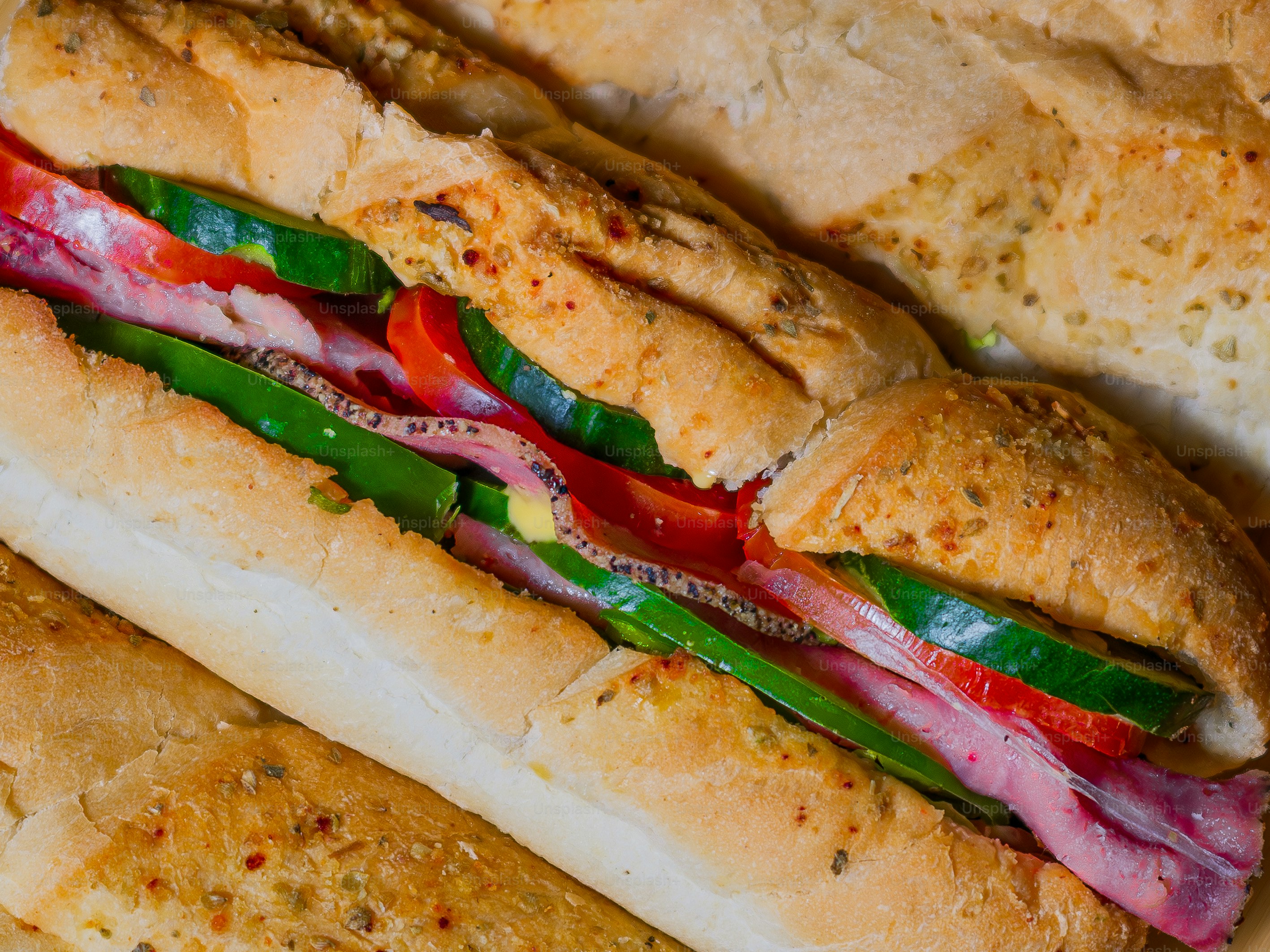 A sub sandwich with meat and vegetables on it