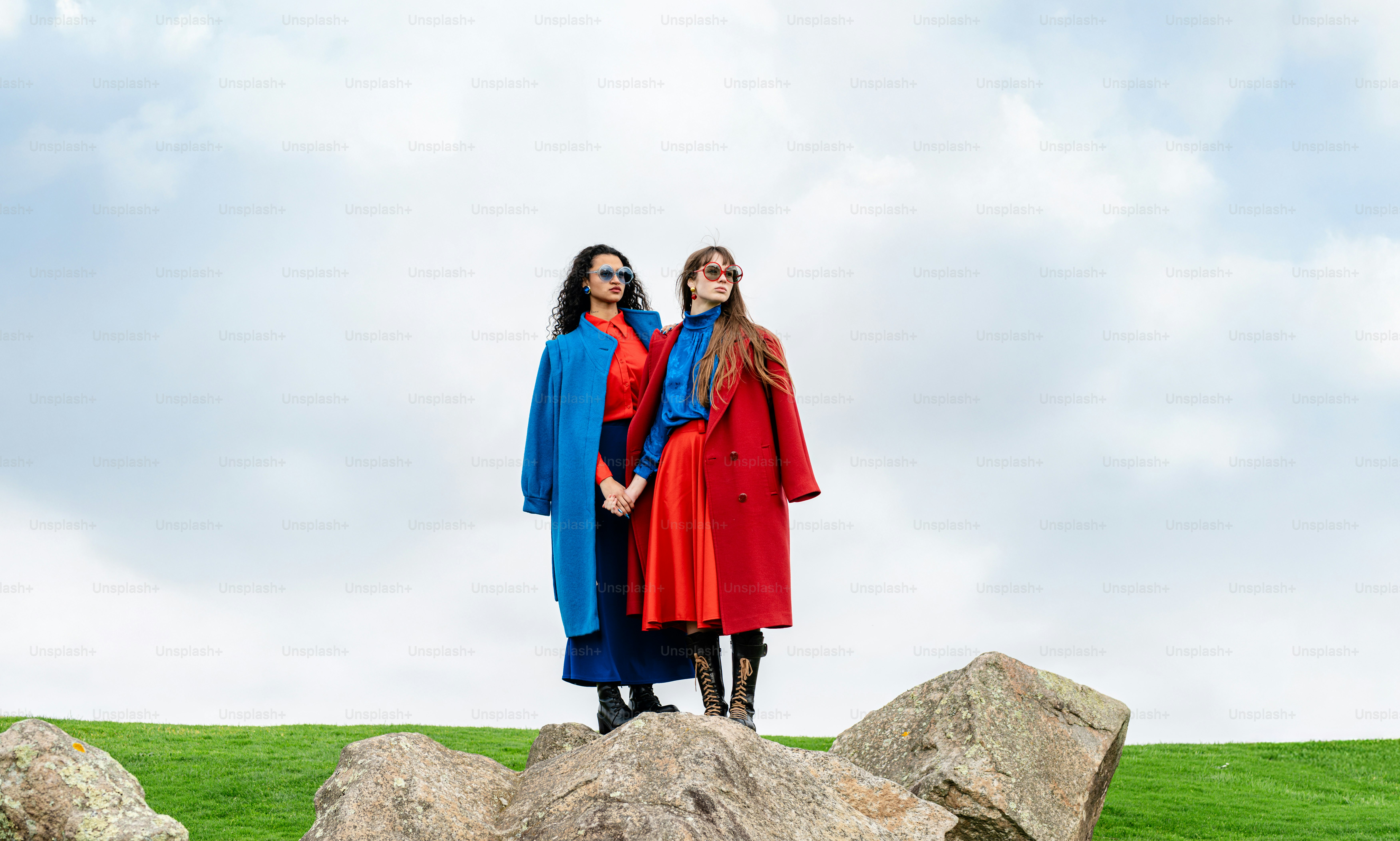 Two women standing on top of a rock formation