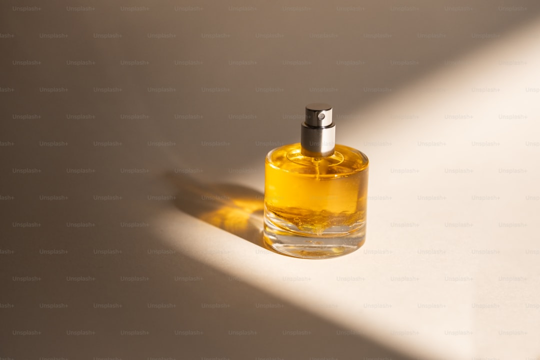 A bottle of perfume sitting on a white surface